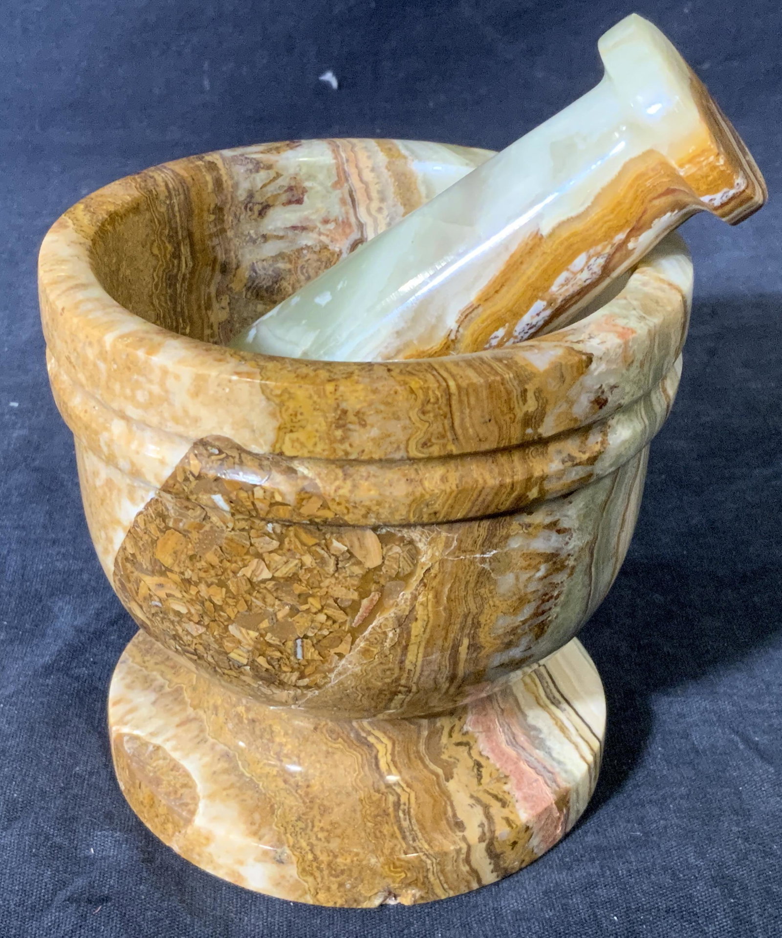 Hand Carved Natural Stone Mortar & Pestle: Hand carved natural stone mortar and pestle, no apparent inscriptions or markings, stone appears sedimentary in brown and green, surface is well polished, mortar measures 4 inches tall and 4 inches wi