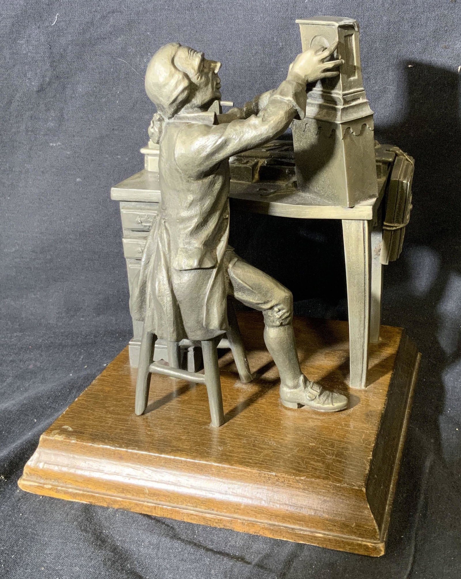 Limited Edition Worcester Pewter Sculpture: Limited Edition Worcester Pewter sculpture, text to side of sculpture reads ‘Worcester Pewter 93/2500’, subject a man in colonial a outfit working on a clock at his desk, piece measures 8 inches t