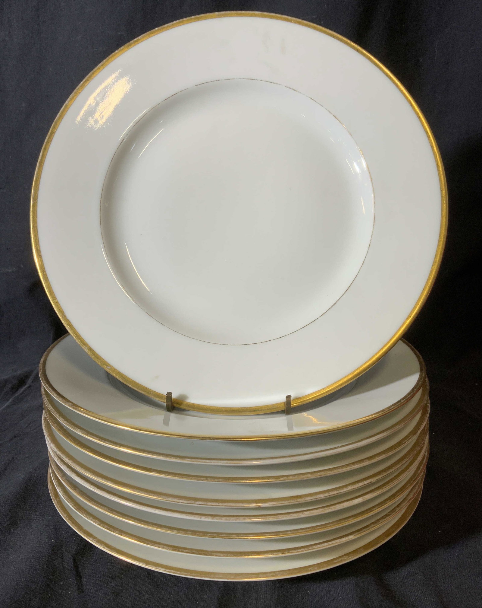 Set 9 Trademarked PIRKENHAMMER Plates: Set of 9 plates. Underside is trademarked and reads as PIRKENHAMMER CZECHOSLOVAKIA, COIN GOLD WHITENHOUSE. Rims of plates are colored with gilt paint, measures approx 10 inches in diameter. Wear is co
