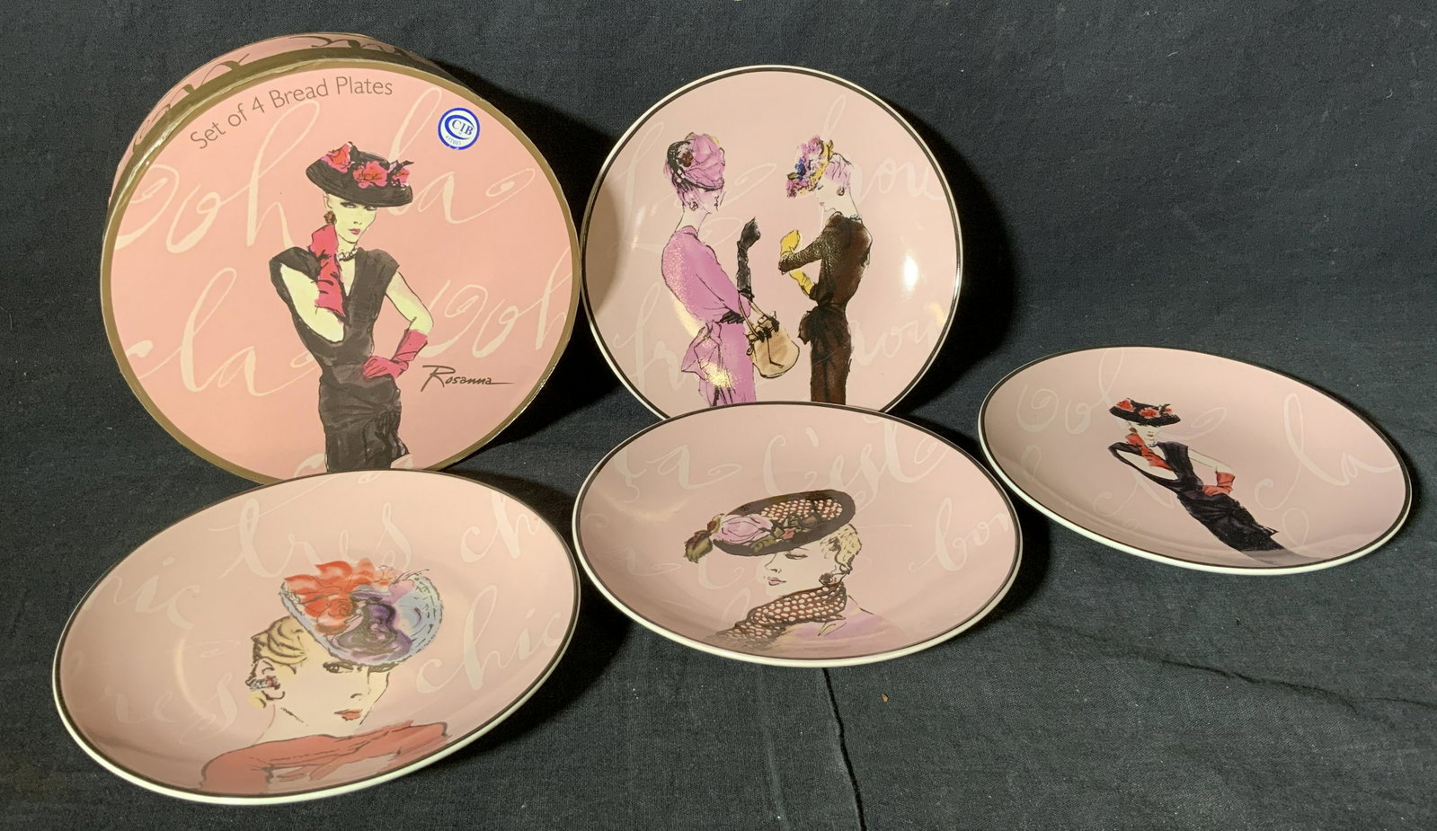Set of 4 Rosanna Fashion Bread Plates: Set of 4 Rosanna Fashion bread Plates, underside of each plate and box reads ‘Rosanna Made in China’, comes in original box, each plate is colored pink with a picture fashion model on it, each mea