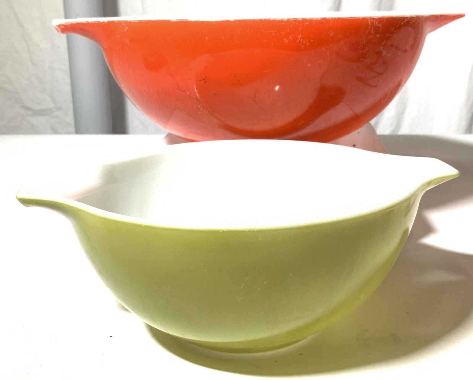 Collectible Pyrex Mixing Bowls, 2: Vintage Pyrex mixing bowls, large and medium size with mid century bright colors ( lime and red), side handles/ pouring scoop spout. Both Hallmarked on underside. Made in USA large measures 10.25 in d