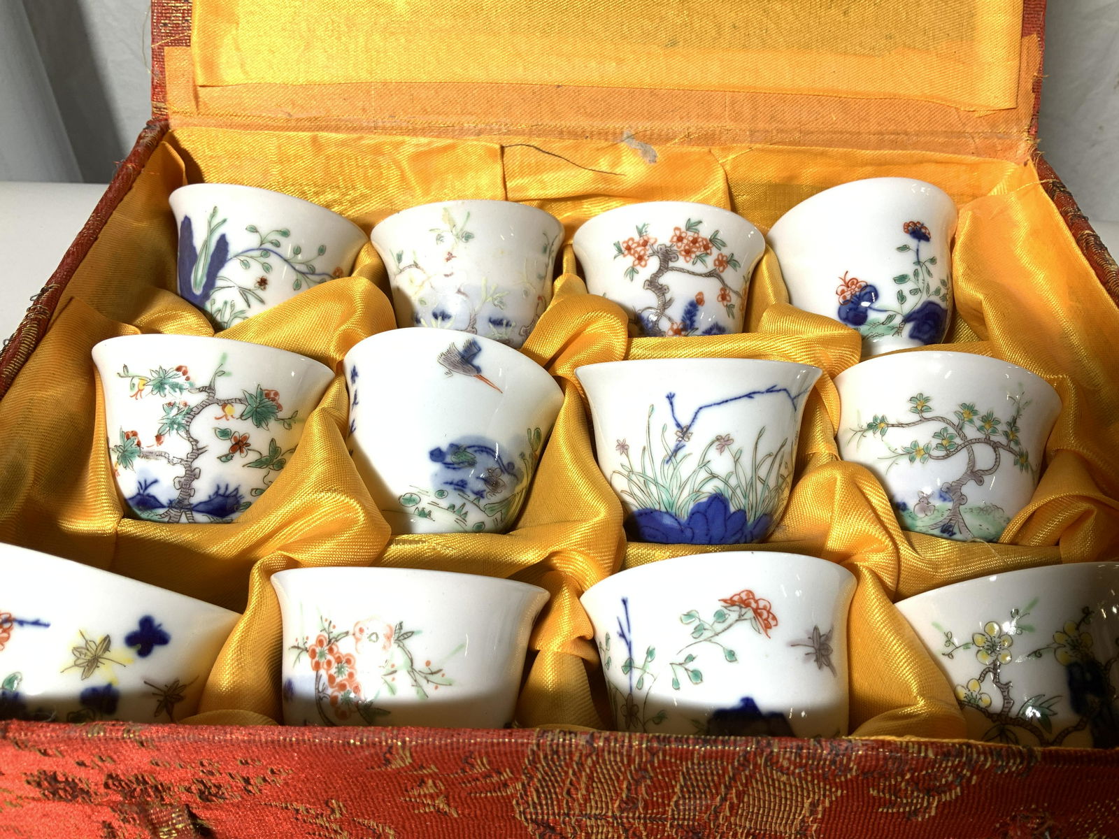 Boxed Set Signed Asian Porcelain Tea Cups 12: Hand Painted Asian tea cups , fine bone China, each with original design, each signed with Chinese characters, 2.25 in diameter, 2 in ht. Comes in Asian Fabric Box, vintage set. Asian Tea cup Cizhou s