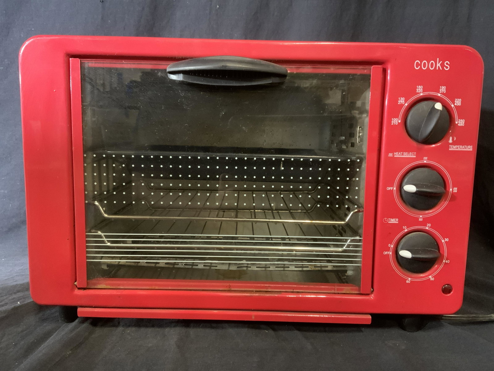 COOKS Toaster Oven: Red toaster oven from COOKS. MEASURES APPROX 12.5 inches W, and 19 inches W. Wear is consistent with age and use. Property of a multigenerational Brooklyn collectors estate. Property of Multi Generati