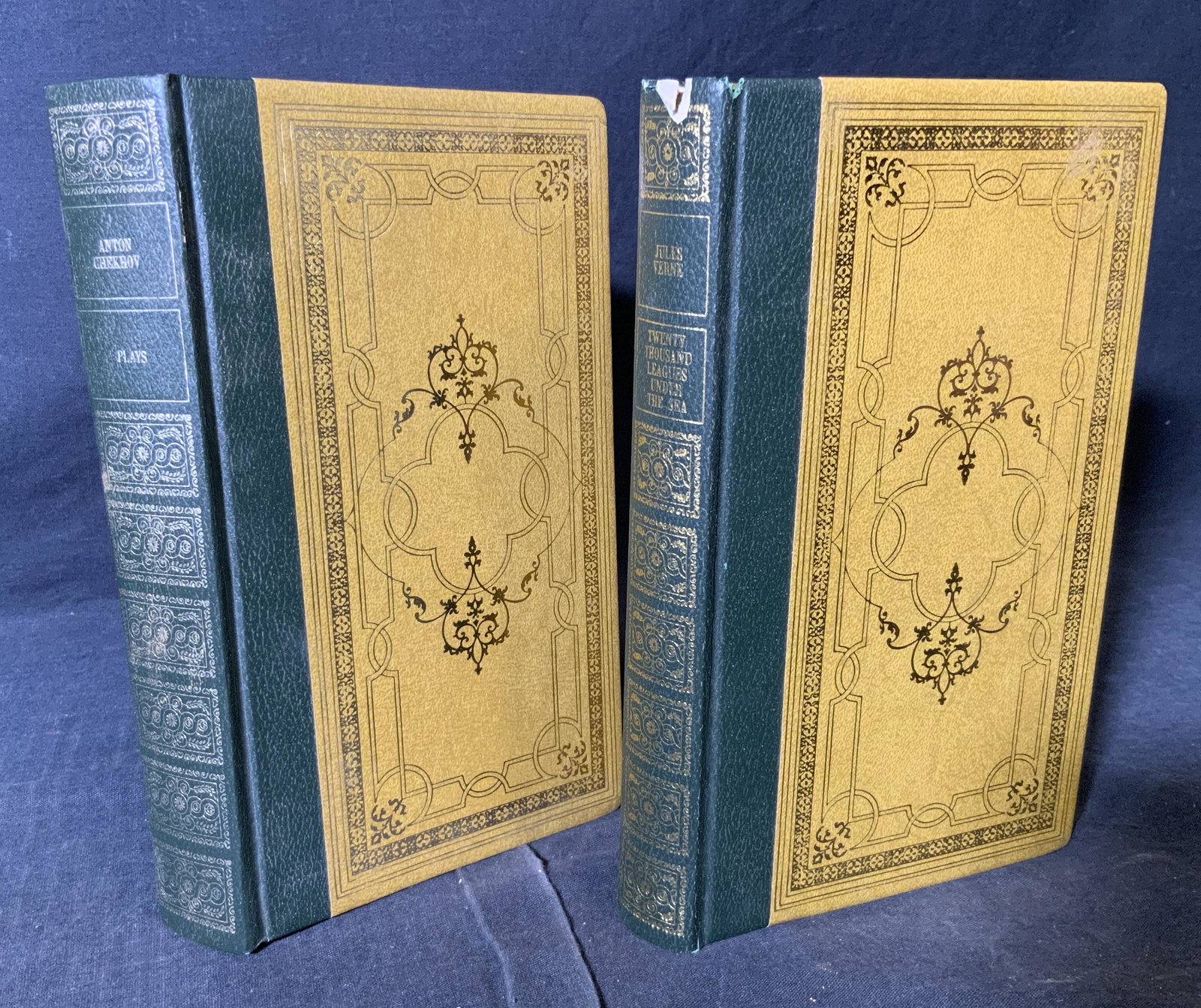 2 Vintage Bound Fictional Books: 2 Vintage bound Fictional Books, lot includes ‘Jules Verne’s 20,000 Leagues under the sea’ and ‘Plays by Anton Chekhov’, both have a green leather spine and a yellow binding with gold inscri