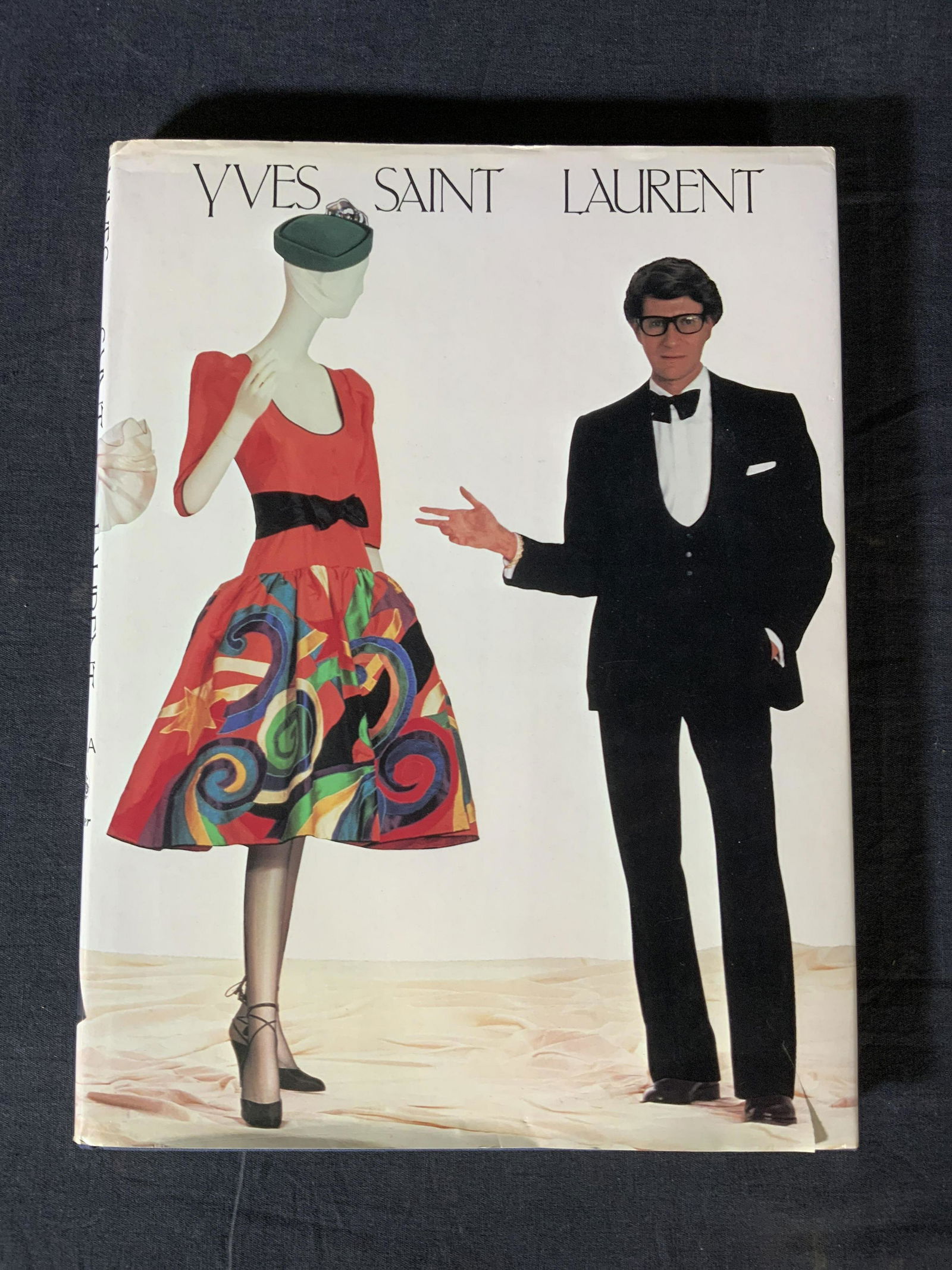 Yves Saint Laurent Coffee Table Book: Yves Saint Laurent Coffee Table Book, inscription reads ‘Yves Saint Laurent MMA Potter’, measures 12 1/4 x 9 1/4 inches, surface wear and tear to dust jacket, Yves Saint Laurent, coffee table book