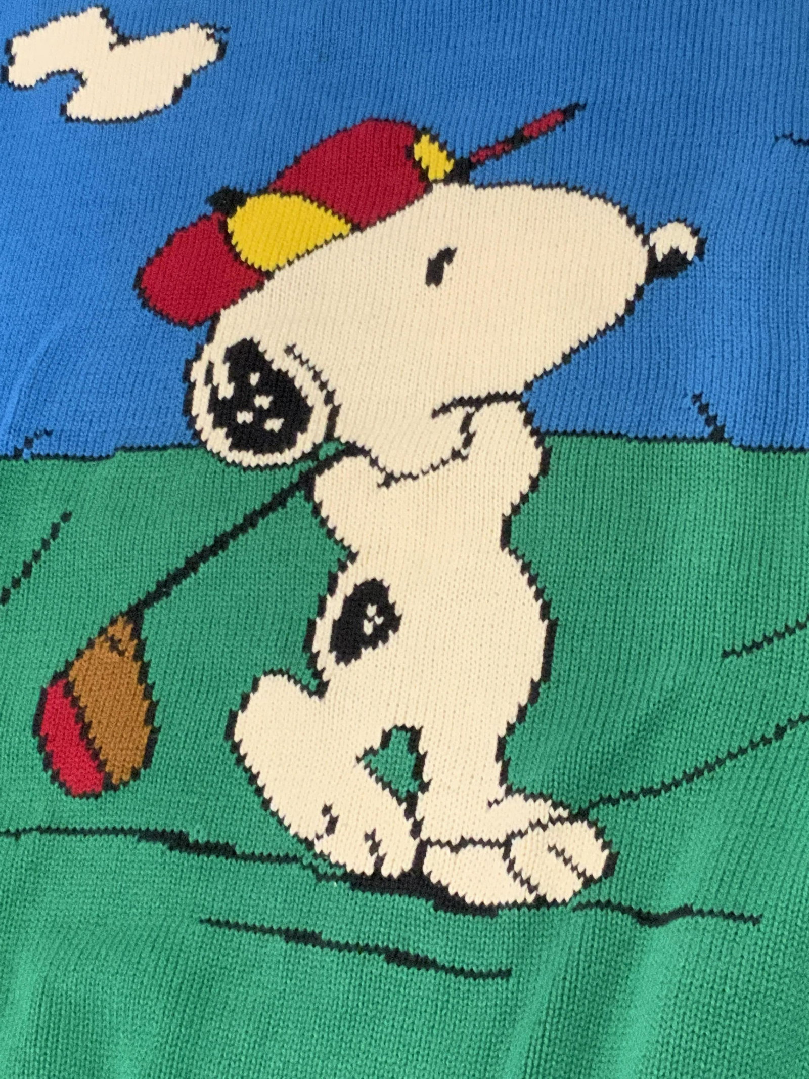 BILLDITFORT Snoopy & Woodstock Motif Sweater: A collectible sweater featuring Snoopy, from The Peanuts. Snoopy is depicted golfing on the obverse. On the reverse, Snoopy is seen with multiple Woodstocks. The tag reads BILLDITFORT, SCHULZ, XL. Pri