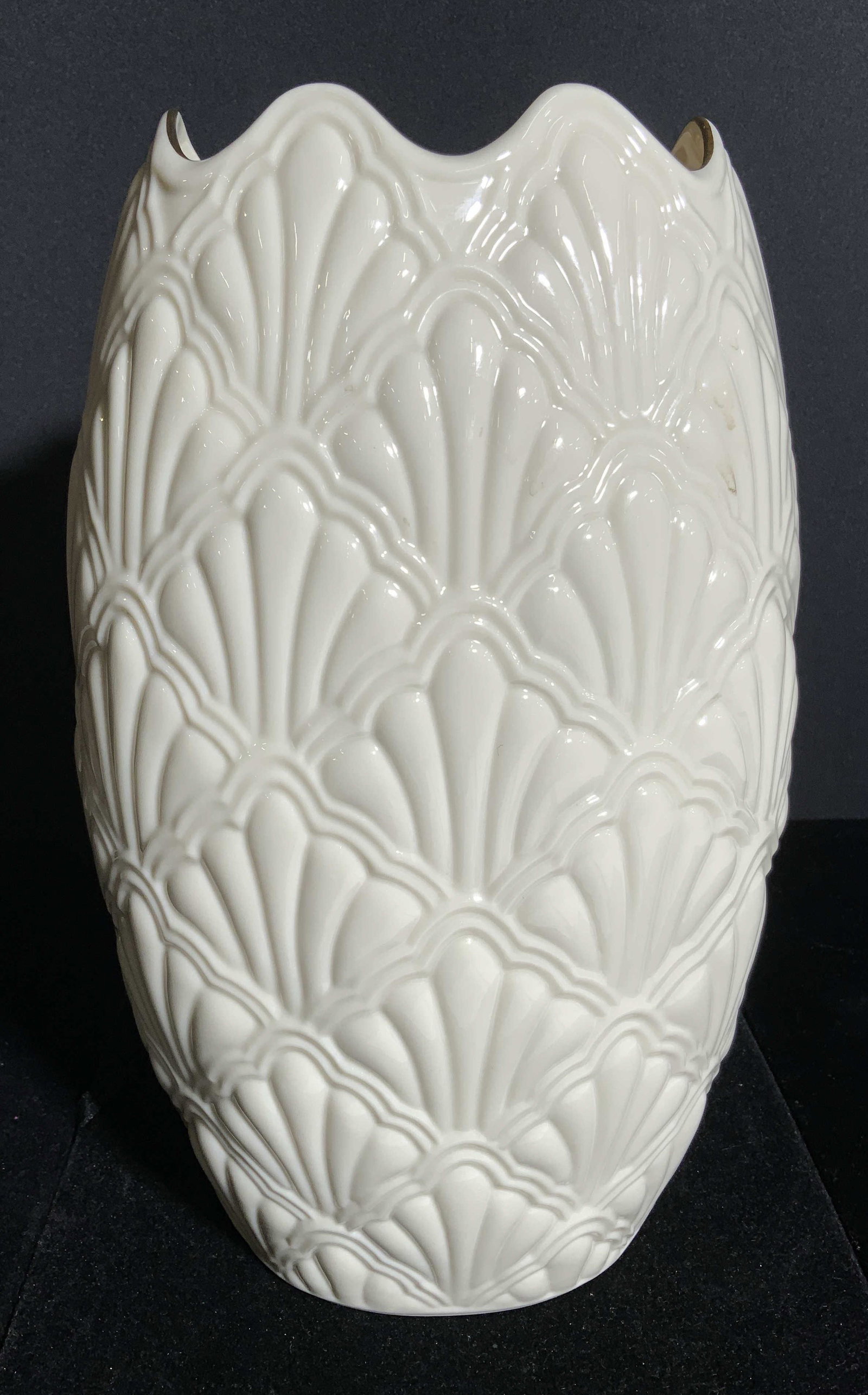 LENOX Porcelain Vase W Gold Toned Rim: Underside of piece is marked LENOX MADE IN USA. Vase is cream toned & porcelain. Rim is gold toned with wavy structure. Contains beveled geometric pattern detail on exterior. Vase, porcelain vase, Len