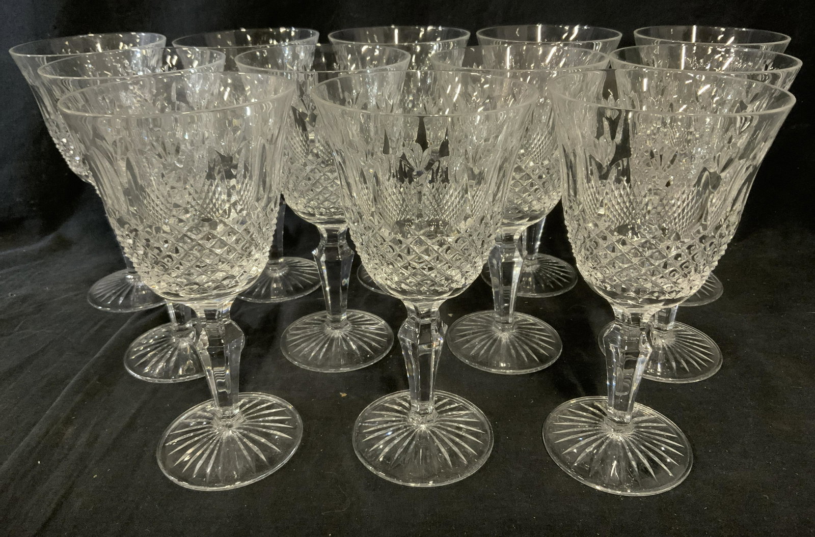 Group Lot 12 ROYAL DOULTON Crystal Goblets: Group lot of 12 cut crystal goblets, by ROYAL DOULTON. Decorated with reticulated, scalloped and starburst patterns. Each measures approx 7.75 inches H, 3.5 inches in diameter. Some chipping present. 