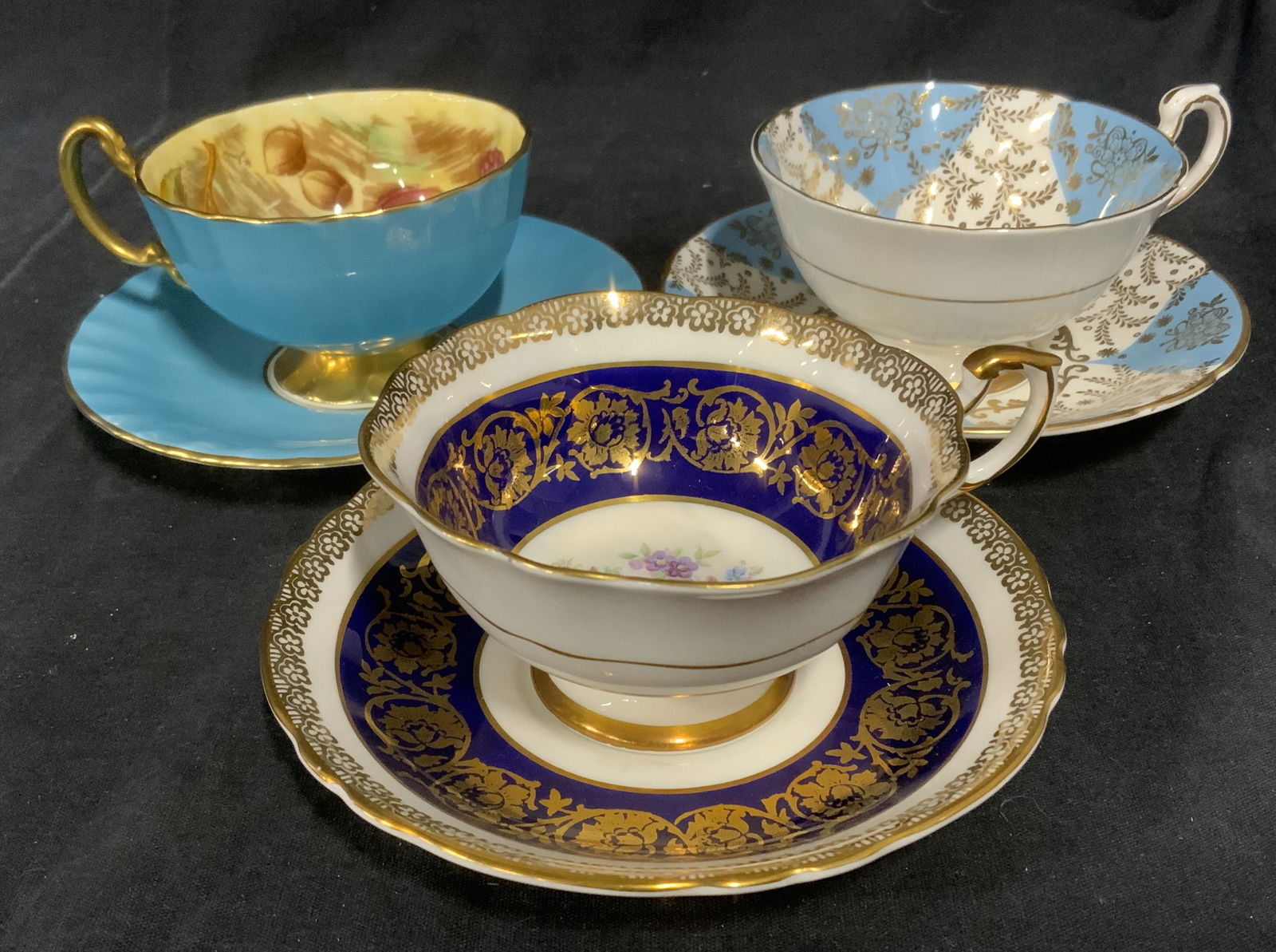6 Piece Ceramic Tea Cups & Saucers: Six piece lot. Includes 3 cups and 3 saucers, all appear to be hand painted or include hand painted elements. Underside reads as AYNSLEY ENGLAND BONE CHINA, BY APPOINTMENT TO HER MAJESTY THE QUEEN MAN