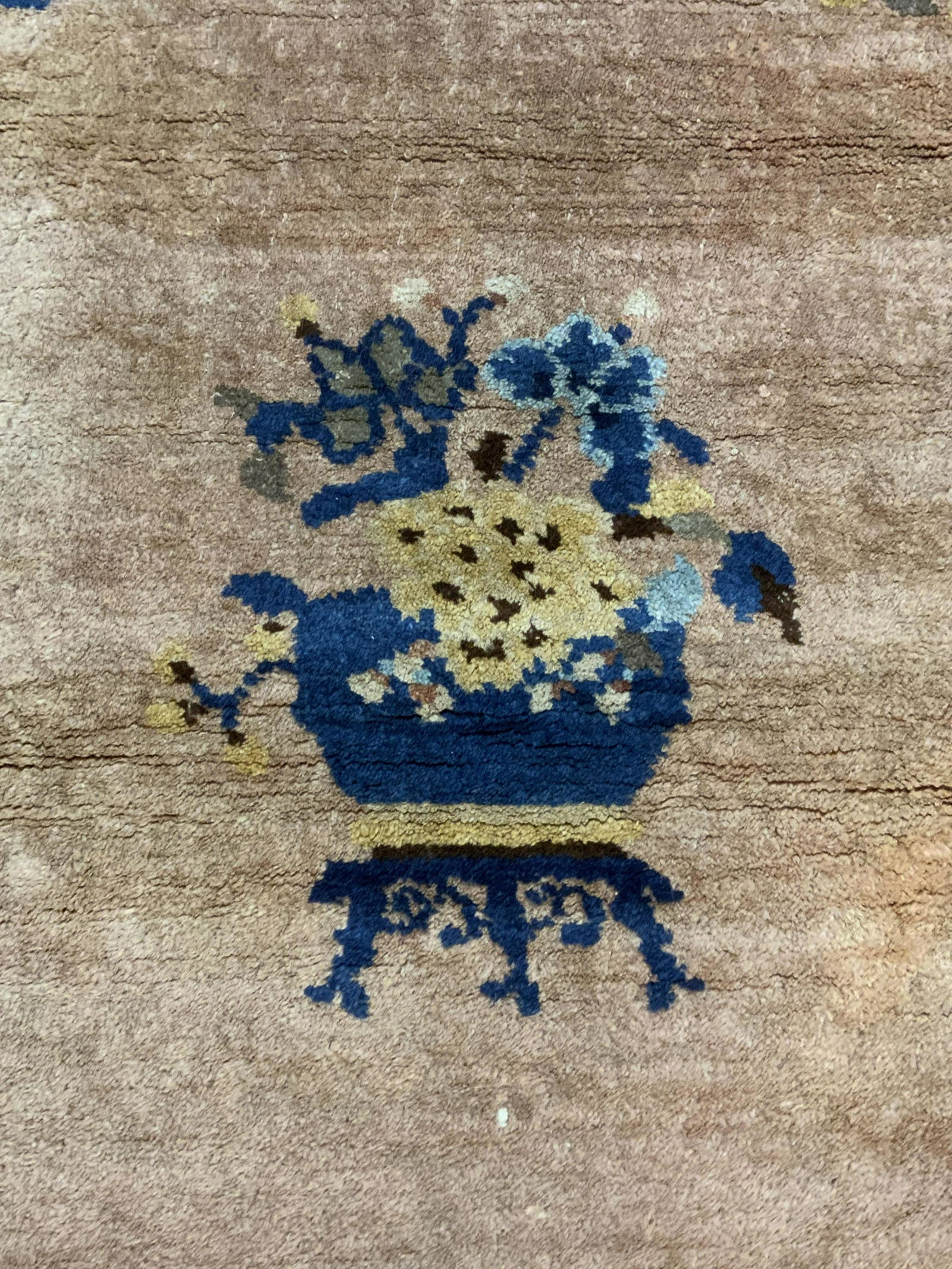 Vintage Art Deco Carpet: Vintage Art Deco carpet. Ends appear to have been fringed. Decorated with floral and leaf like patterns. Center of rug depicts a potted plant. Wear is consistent with age and use. Measures approx 68 i