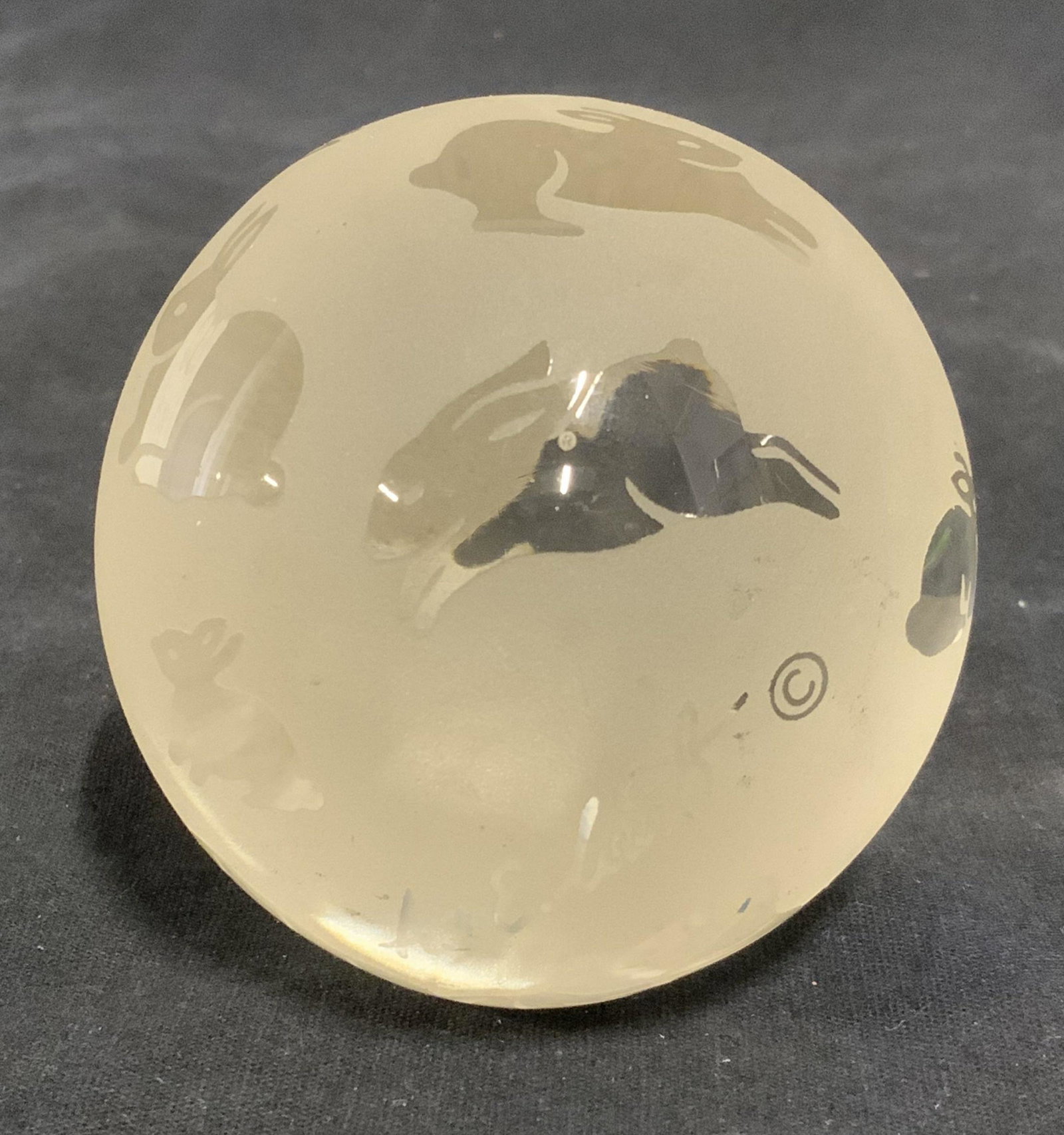 ARTHUR COURT DESIGNS Paper weight: Spherical glass paperweight. Decorated with an all over rabbit design, label on underside reads as ARTHUR COURT DESIGNS COPYRIGHT 1993 MADE IN TAIWAN. Measures approx 3 inches in diameter. Wear is con
