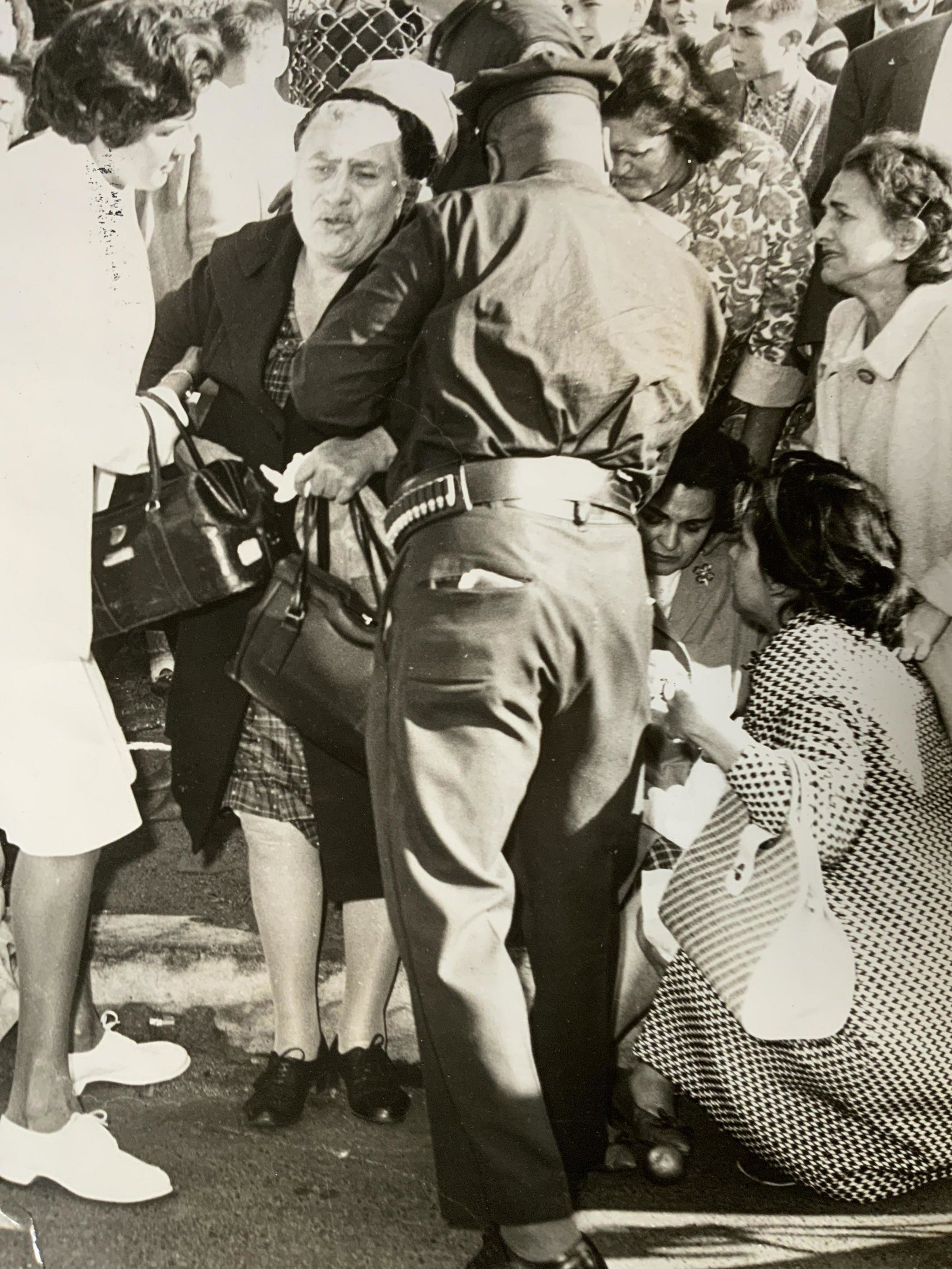 Vintage Photograph ‘Bus Victims’: Vintage Photograph ‘Bus Victims’, inscriptions read ‘Bus Victims’ and ‘News’, subject panicking figures being tended to by a police officer, measures 20 x 15 7/8 inches, some folds to phot