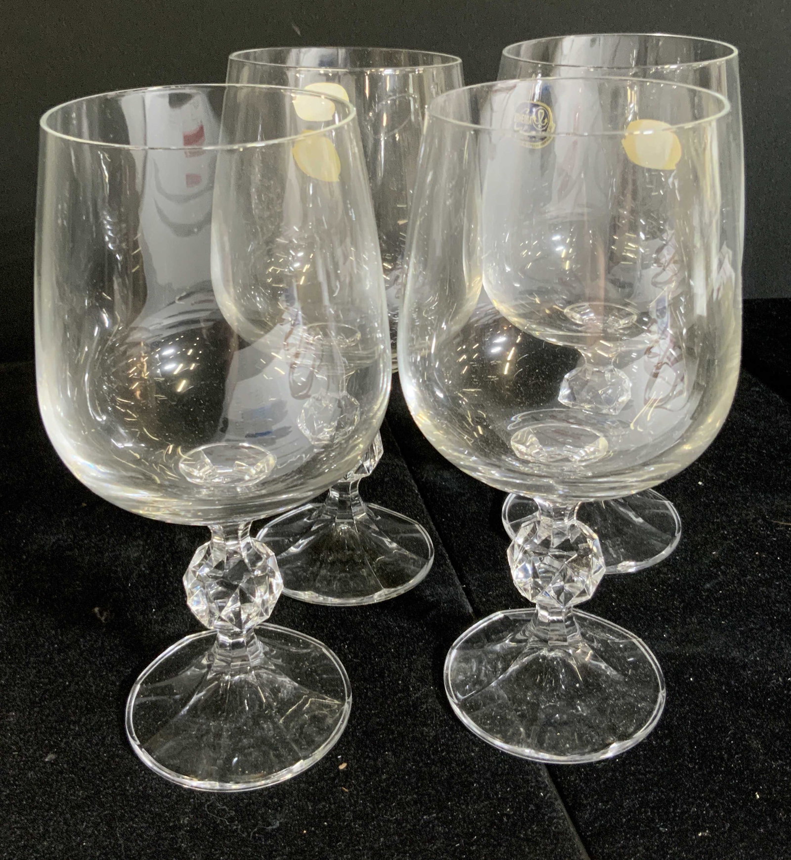 4 CLAUDIA CRYSTAL COLLECTION Wine Glasses, Org Box: Four colorless crystal wine glasses in their original box. Possibly never used. Box reads CLAUDIA CRYSTAL COLLECTION. Wine glasses have cut crystal stems. Original Stickers still on all four glasses. 