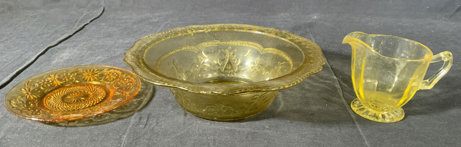 Lot 3 Depression Glass Dishes & Creamer: Lot 3 Depression Glass Dishes & Creamer, no apparent inscriptions or marks, saucer measures 6 inches in diameter, creamer measures 3 1/2 inches tall x 4 5/8 inches wide, bowl measures 2 5/8 inches tal