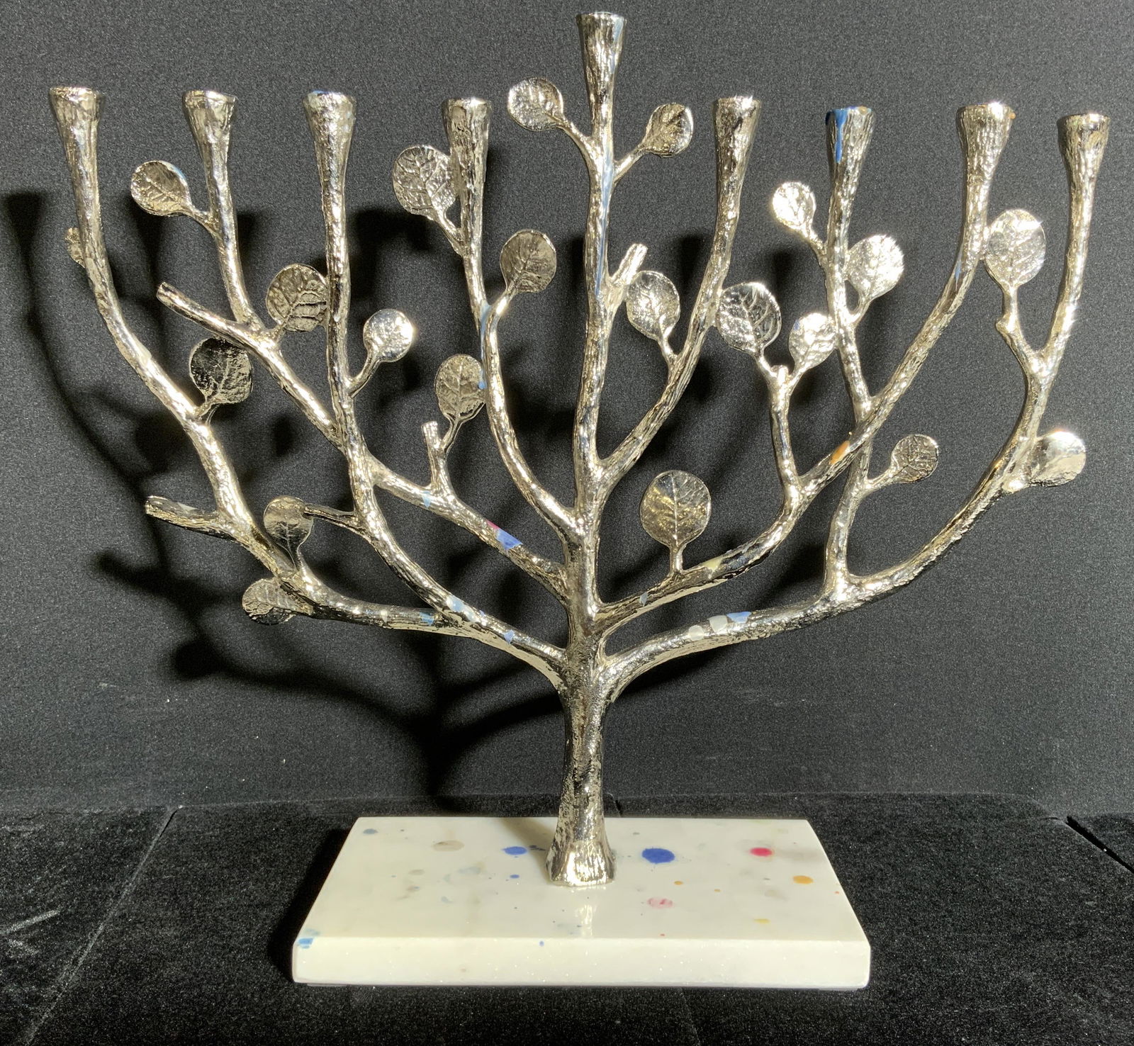 MICHAEL ARAM Signed Pewter Candelabra Menorah: Underside is signed ARAM. Piece is silver toned & appears to be pewter. Base appears to be marble possibly stone with multi toned splat detail. Candelabra has branch & leaf structures as arms. Piece m