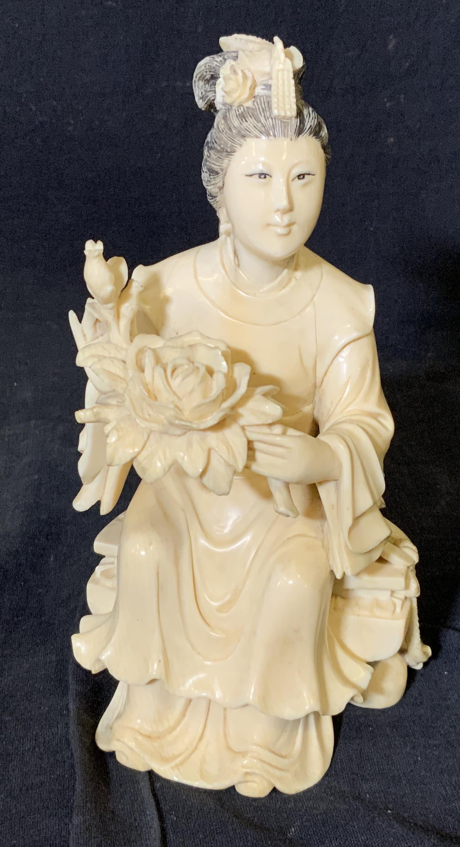 Hand Carved Asian Resin Figural Statue: Hand carved Asian resin figural statue, no apparent inscriptions or markings, material made of resin possibly bone, hair eyes and tassels are the only parts painted black, subject a seated figure hold