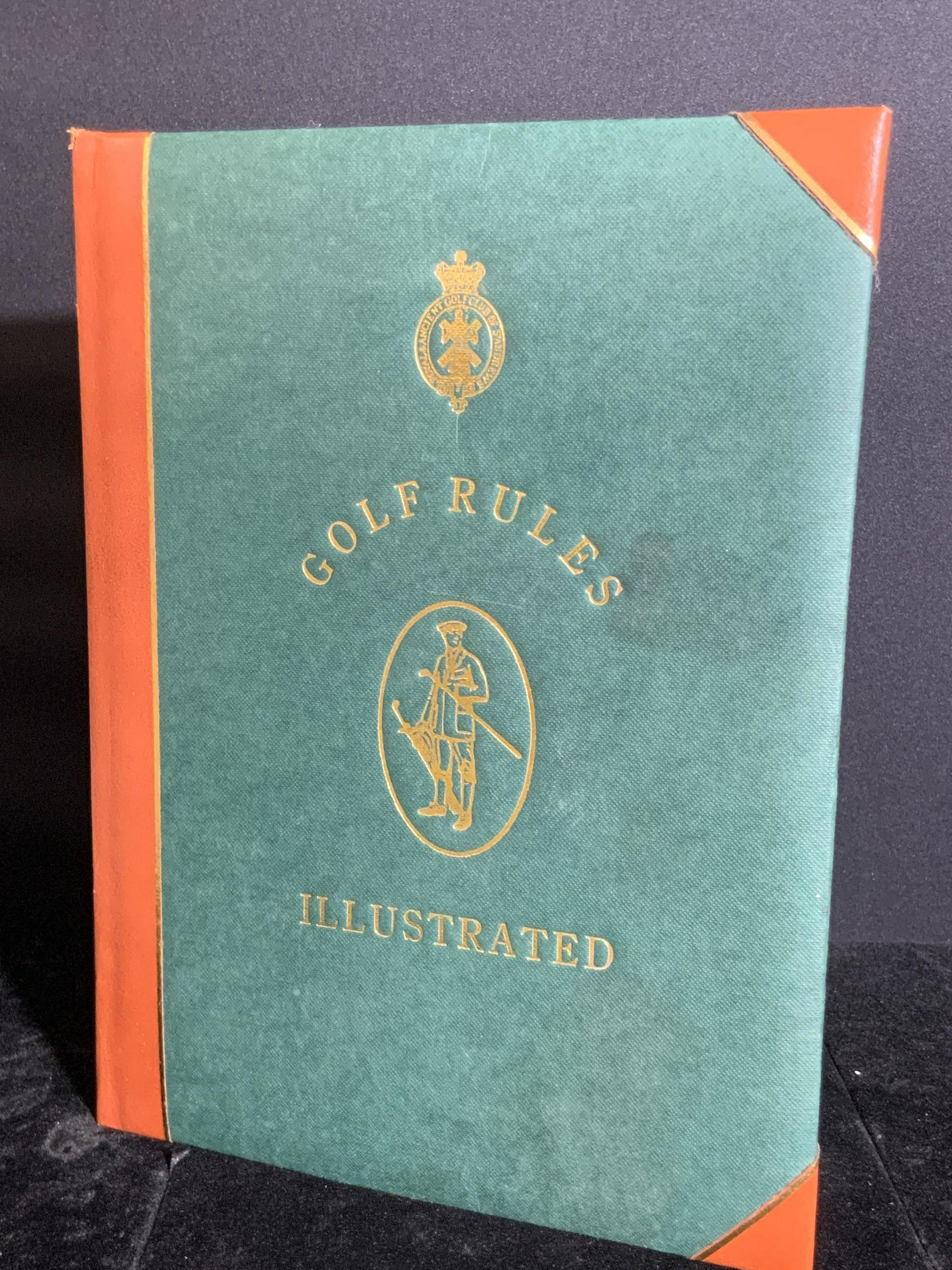 Vintage GOLF RULES ILLUSTRATED Book: A vintage, copyright 1992, book titled GOLD RULES ILLUSTRATED. Seventh edition. Gilt lined pages. Piece has some wear. Approx. 11L x 8W in. Property from F.W. Woolworth CEO Byron DeWitt Miller Estate 