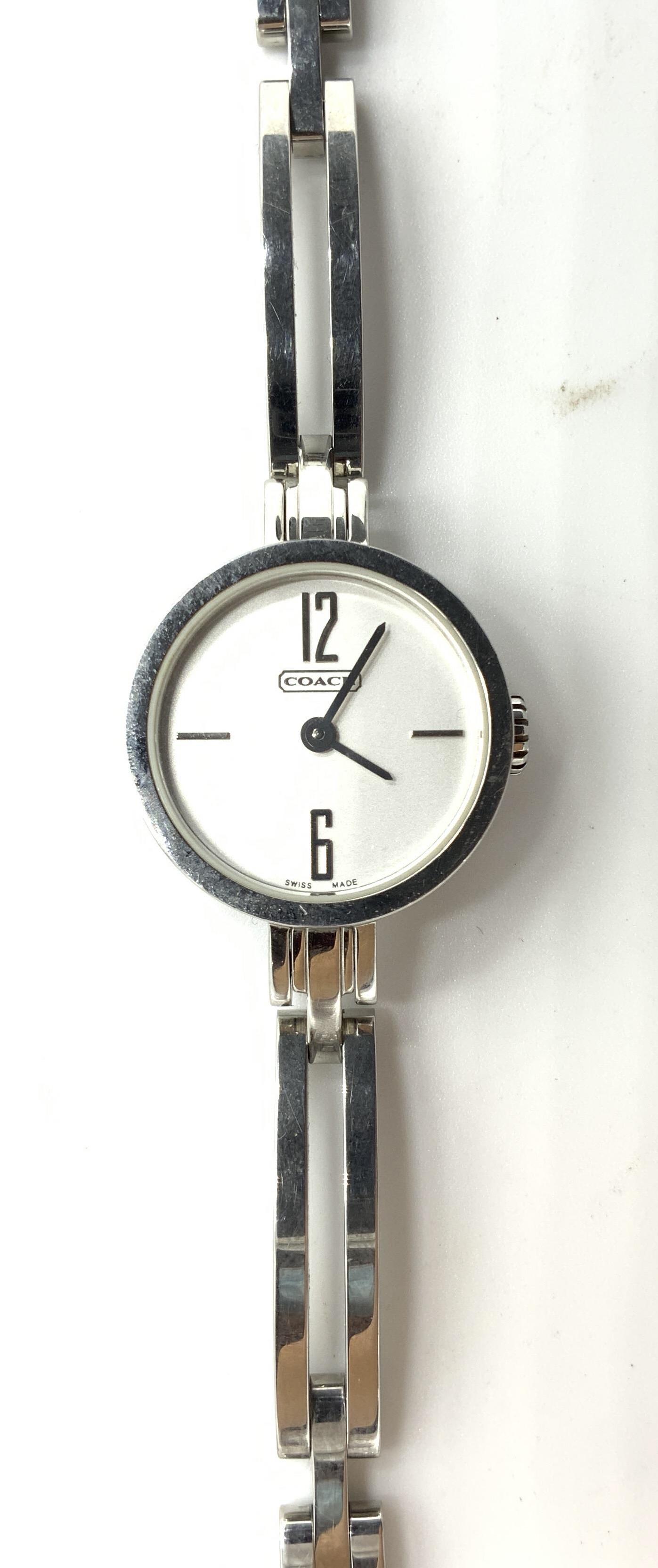 COACH Stainless Steel Women’s Watch: COACH Stainless Steel Women’s Watch, comes in original box, inscriptions read ‘Coach 0201 6 303 034 Stainless Steel Water Resistant 3ATM’, face of watch measures 7/8 inches in diameter, measures