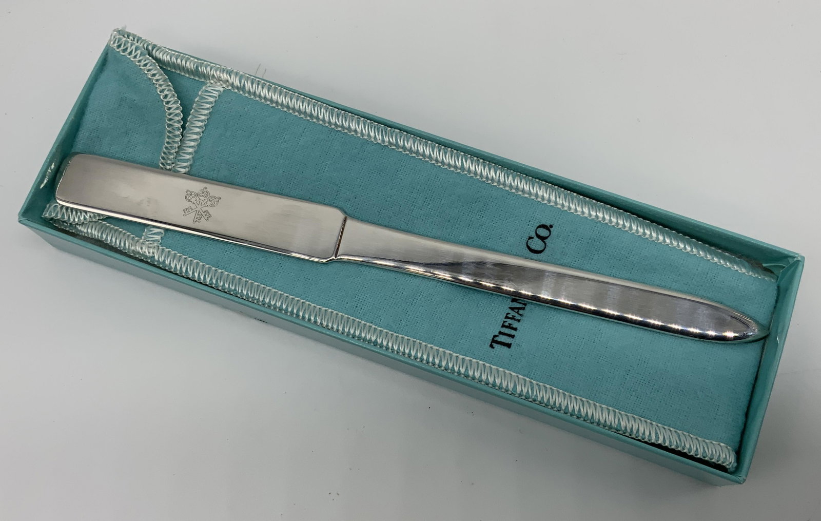 TIFFANY & CO Silverplated Letter Opener: TIFFANY & CO Silverplated Letter Opener, comes in original dust bag and box, inscriptions read ‘Tiffany & Co Silverplate’, measures 7 inches long, surface wear to piece, Tiffany and Co, Silverplat