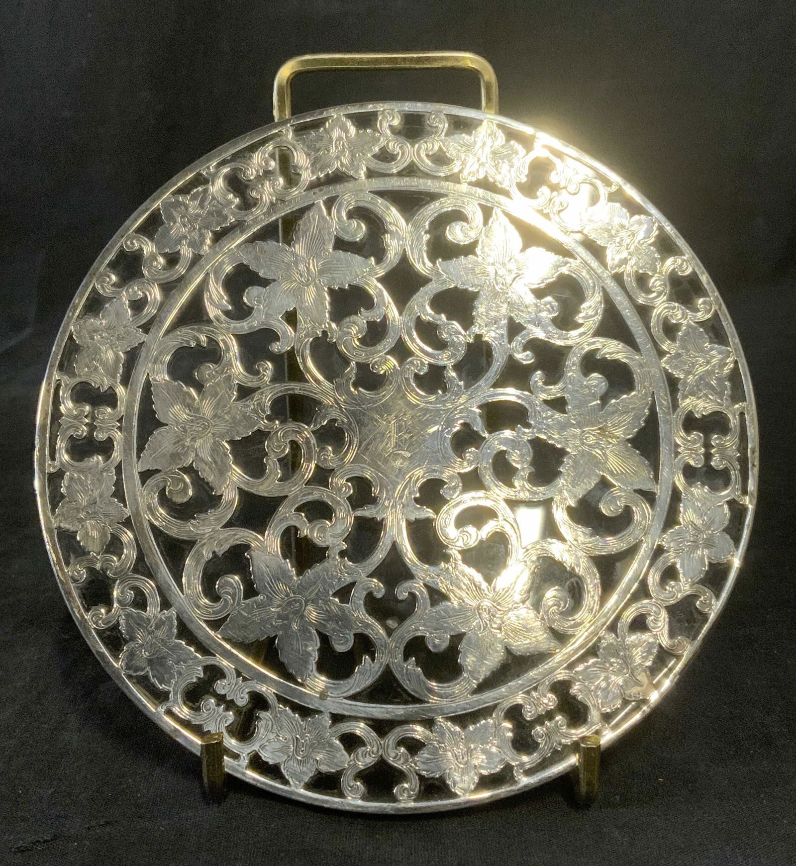 Monogrammed Sterling Silver & Glass Coaster: Vintage, possibly antique, monogrammed coaster. Crafted from glass and sterling silver, marked sterling along sides. Decorated with etchings depicting flowers and swirling vines. Monogrammed with the