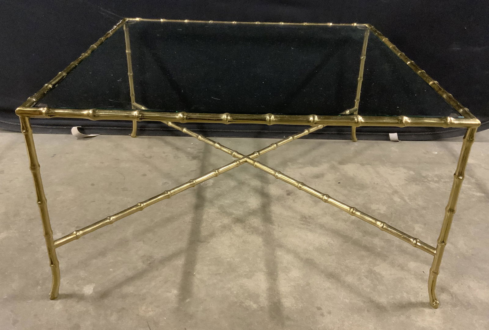 Metal & Glass Bamboo Style Coffee Table: Metal and glass coffee table. Tabletop is glass and removable, frame is metal and cast to resemble bamboo. Legs are joined by an x shaped stretcher. Wear is consistent with age and use. Measures appro