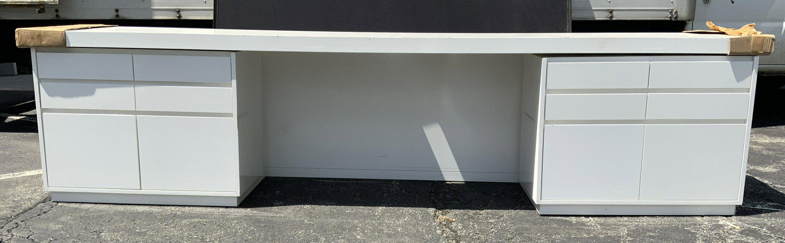 MCM White Toned 12 Drawer Desk: Desk is white toned. Piece appears to be Mid Century Modern. Piece has 12 drawers. Desk includes hardware. Desk measures approx 29 inches Tall 22.5 inches Deep 120 inches long. Desktop has wire hole. 