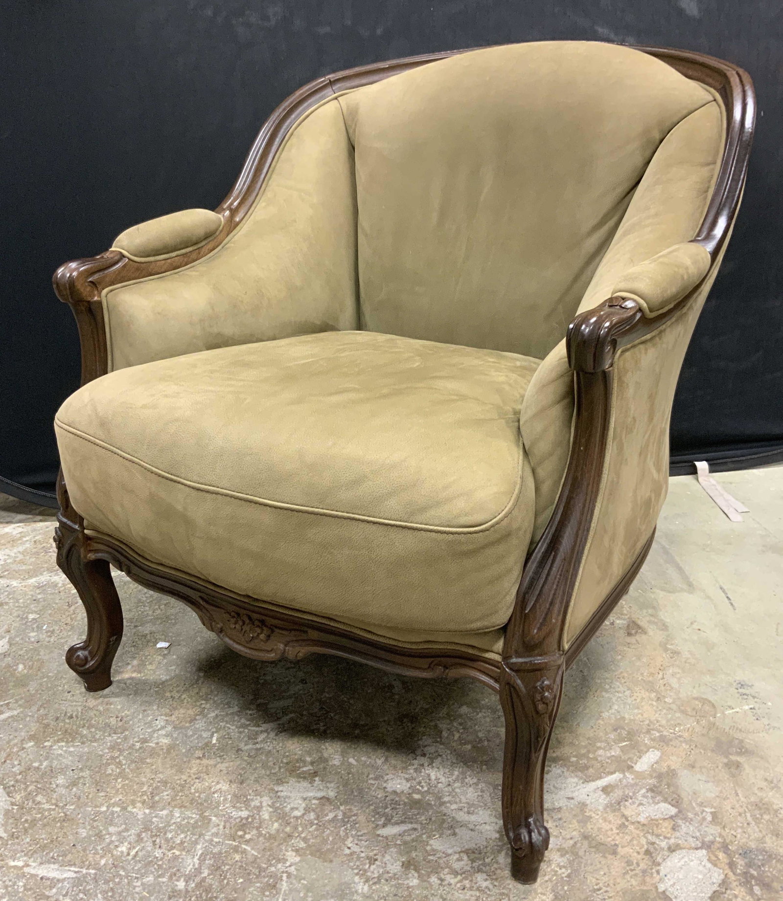 Bergere Style Arm Chair: Bergere style armchair. Upholstery is single welt and olive drab in tone. Legs and arms are decorated with carved detailing, cushion is removable. Cushion secured with Velcro. Wear is consistent with 