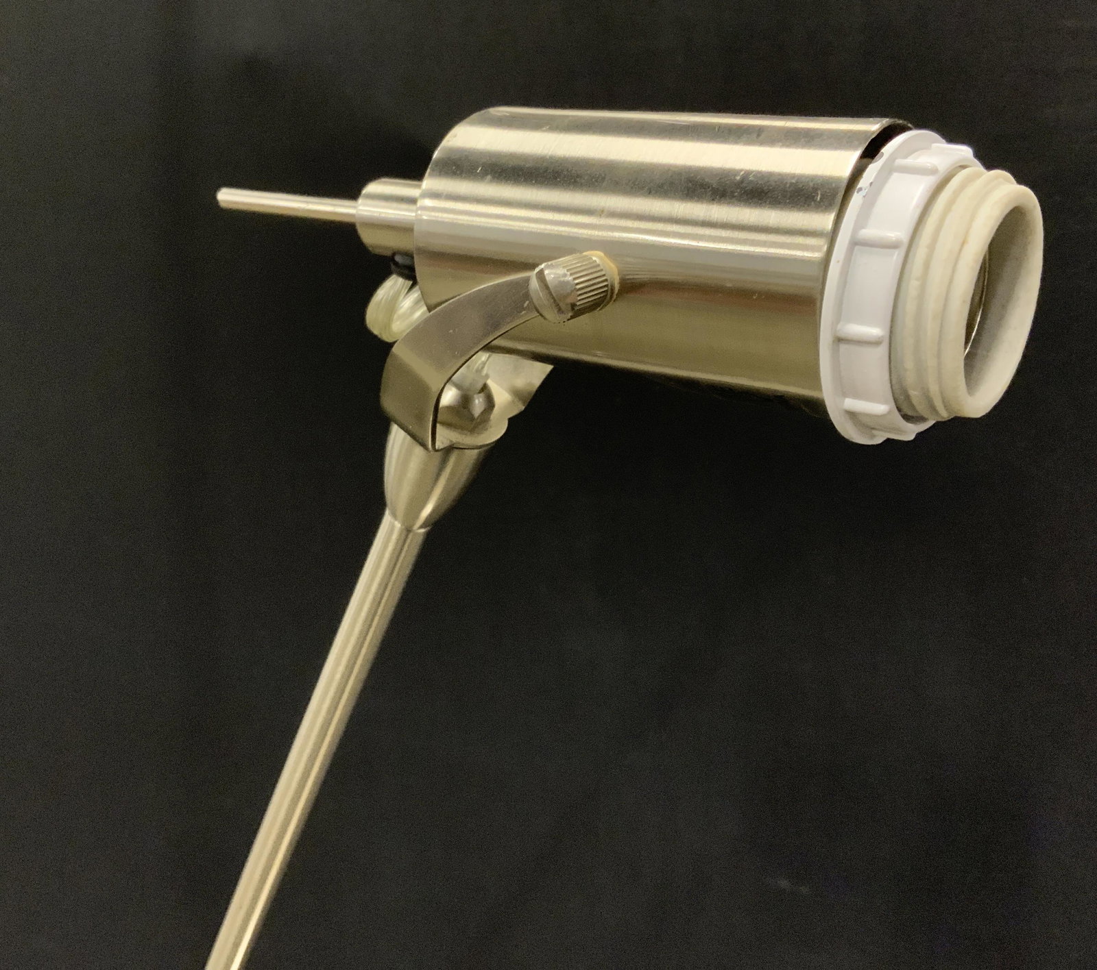 Brushed Metal Floor Lamp: Metal floor lamp, brushed Metal finish. Arm swivels, arm has loosened and needs addressing. Wear is consistent with age and use. Measures approx 60 inches H, and 10 inches W. Lamps, lighting, home dec
