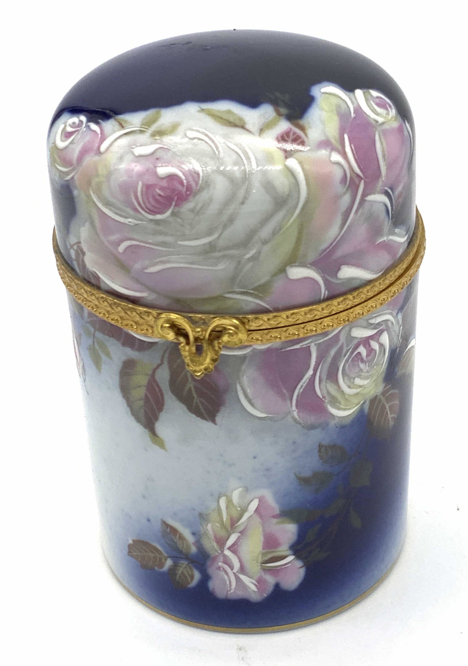 Vntg LIMOGES FRANCE Signed Porcelain Trinket Box: A vintage hand painted and glazed floral porcelain trinket box. The piece is primarily a cobalt blue hue decorated with a pink floral rose motif. Some of the floral accents are raised. Gilt line work 