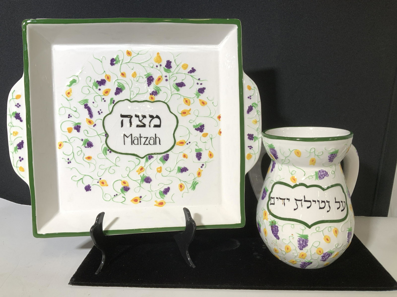 Pair Hand Painted Seder Ceramic Tableware Set: Signed Ceramic ware designed by artist Sharon Muchnuk for Aviv Judaica Imports. Square serving platter with handles, reads Matzah with Hebraic characters, Jug with double handles and Hebraic writing, 