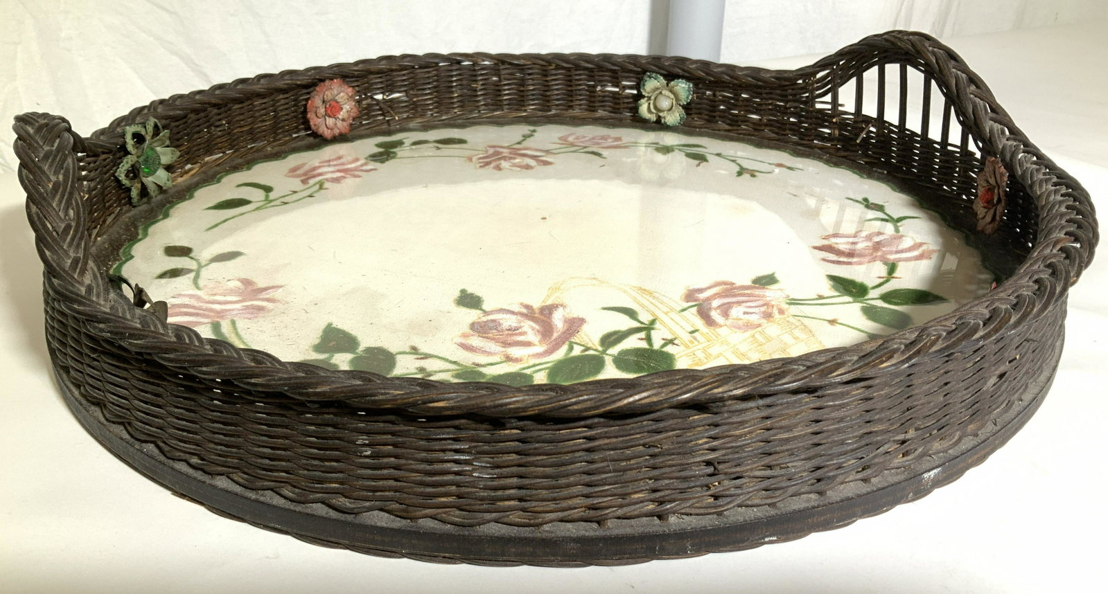 Victorian Wicker & Glass Tray w Embroidery: Vintage Tray , glass base with embroidered cloth under glass, wicker gallery and handles sit upon wood , enameled metal flower ornaments stick into weave of wicker gallery ( need to be permanently aff