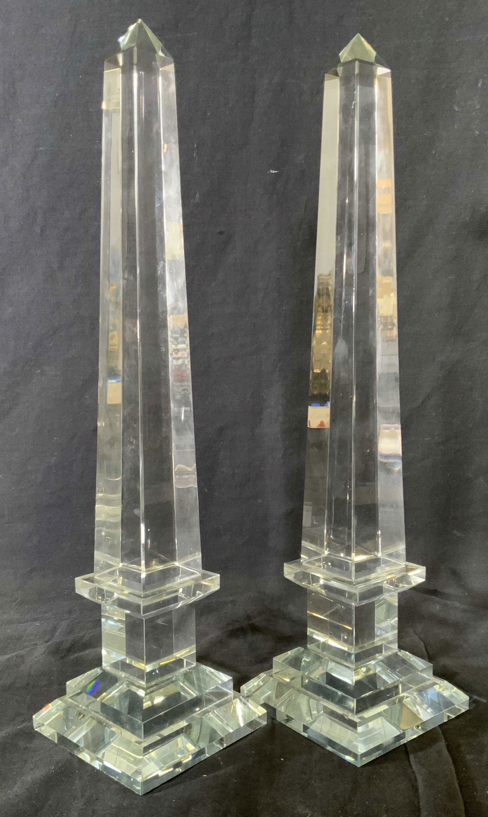 Pair Clear Art Glass Obelisks: Pair clear Art glass obelisks, no apparent inscriptions or markings to either, subject a pair of pedestaled obelisks made of clear cut glass, both ,ensure approximately 16 inches at tallest point, som