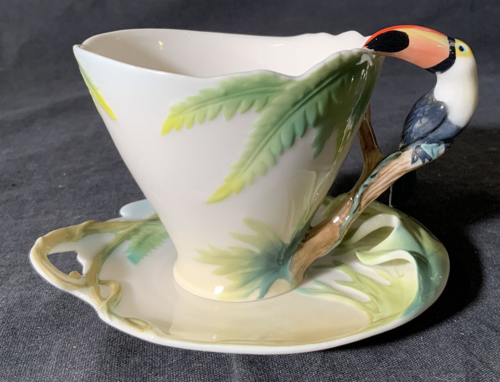 FRANZ Porcelain Teacup & Saucer: FRANZ Porcelain Teacup & Saucer, comes in original box, stamp reads ‘FRANZ Lei Chiu Hui’, teacup measures 2 7/8 inches tall x 4 inches wide, saucer measures 4 1/2 x 3 7/8 inches, surface wear and 