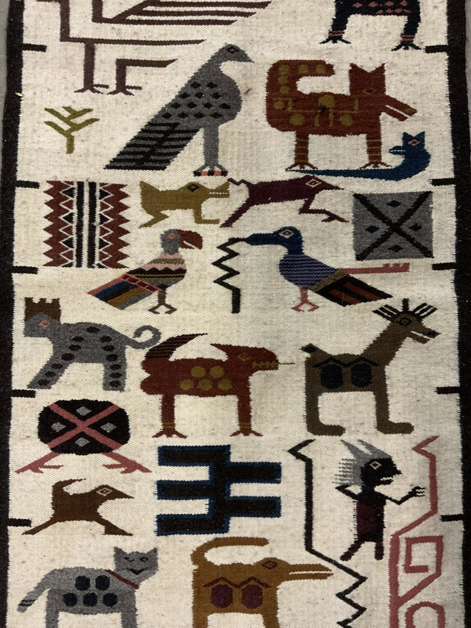 Handmade Wool Area Rug: Wool area rug, rug is hand made. Depicts a number of animals. Wear is consistent with age and use. Measures approx 44 inches long, 26 inches w. Area rug, handmade rug, decorative accessories, vintage 