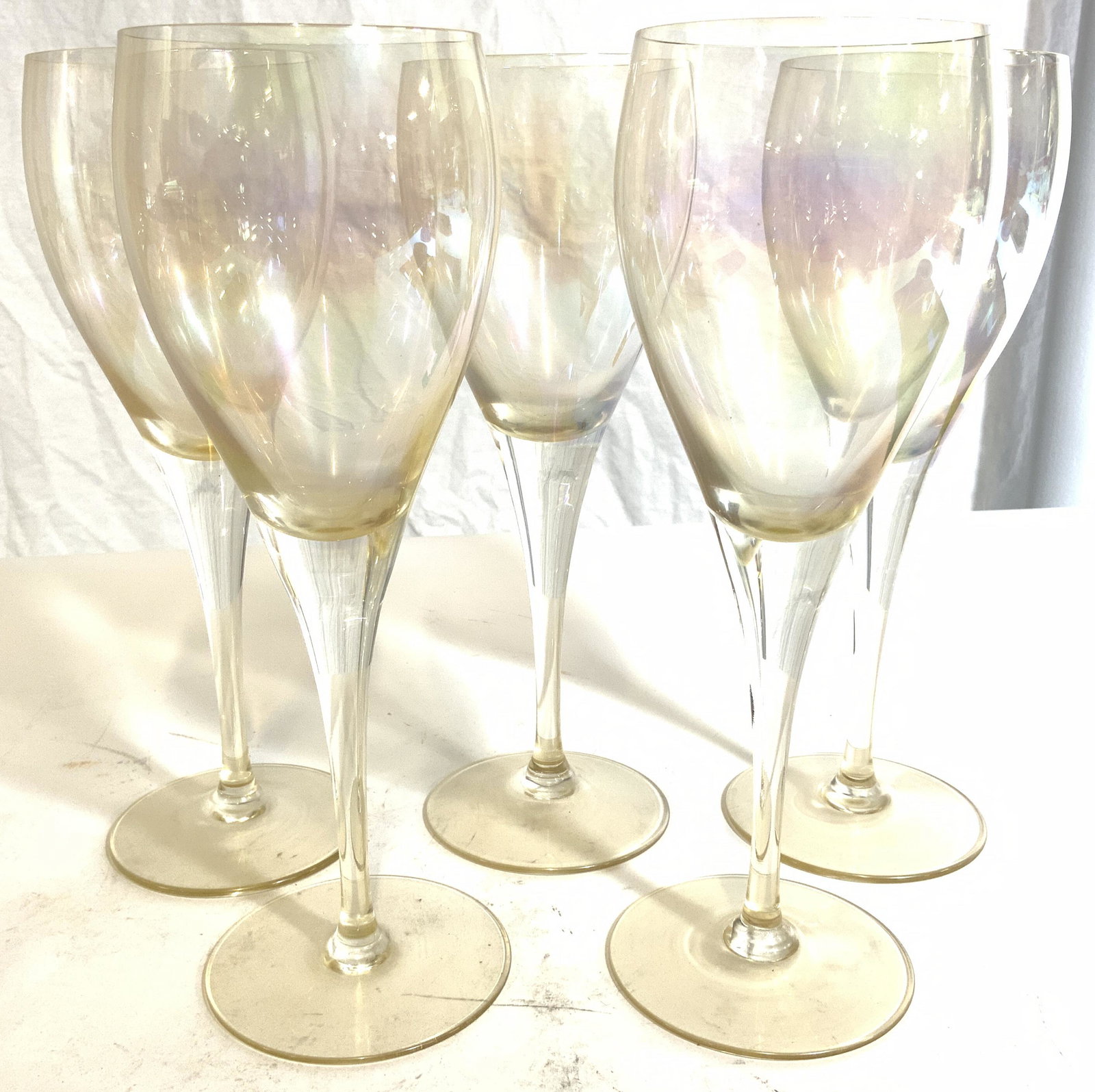 Set 5 Art Glass Stemware Wine Glasses: Lot includes 5 glasses. Each have pearlescent luster. Base of stems have circular shape. Each measure approx 8.25 inches tall 3 inches wide. Art glass, Art glass stemware, stemware, wine glasses, beve