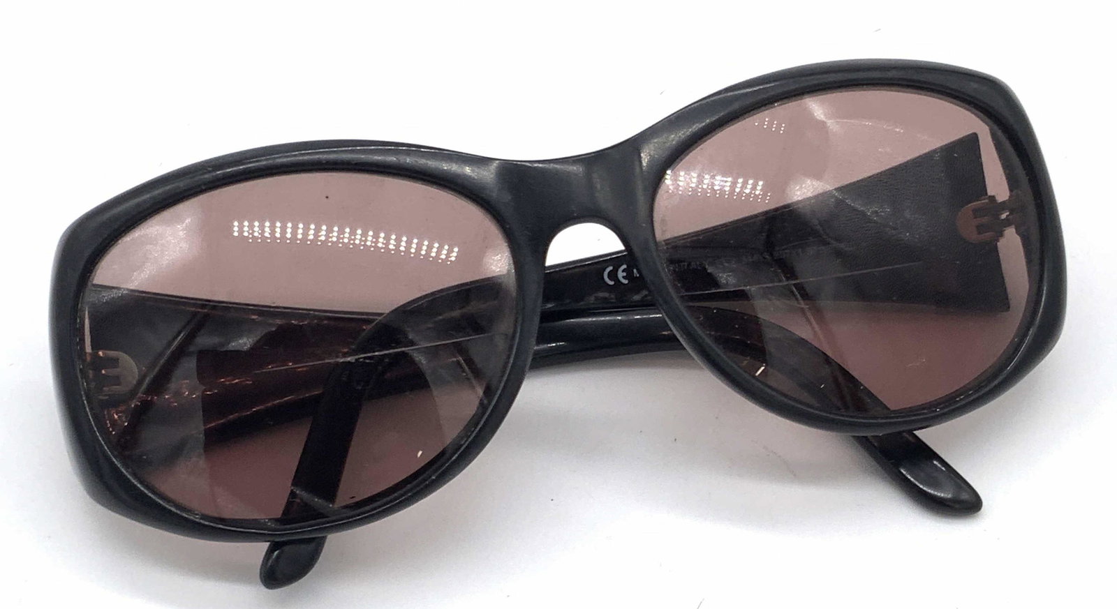 VALENTINO Italian Black Framed Sunglasses: A pair of Valentino black framed sunglasses. The exterior reads: Valentino. Interior reads: Made in Italy. Piece possesses some wear consistent with use. Approx. 2L x 5W in. Valentino sunglasses, fram