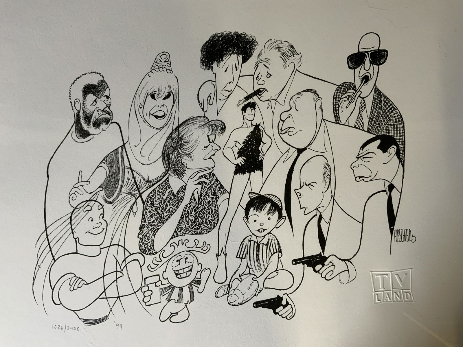 AL HIRSCHFIELD TV Land Lithograph: AL HIRSCHFIELD TV Land Lithograph, inscriptions read ‘HIRSCHFIELD 5’, ‘TV Land’, edition and date read ‘1026/2400’, ‘99’, subject various television characters, measures 16 1/2 x 20 3/