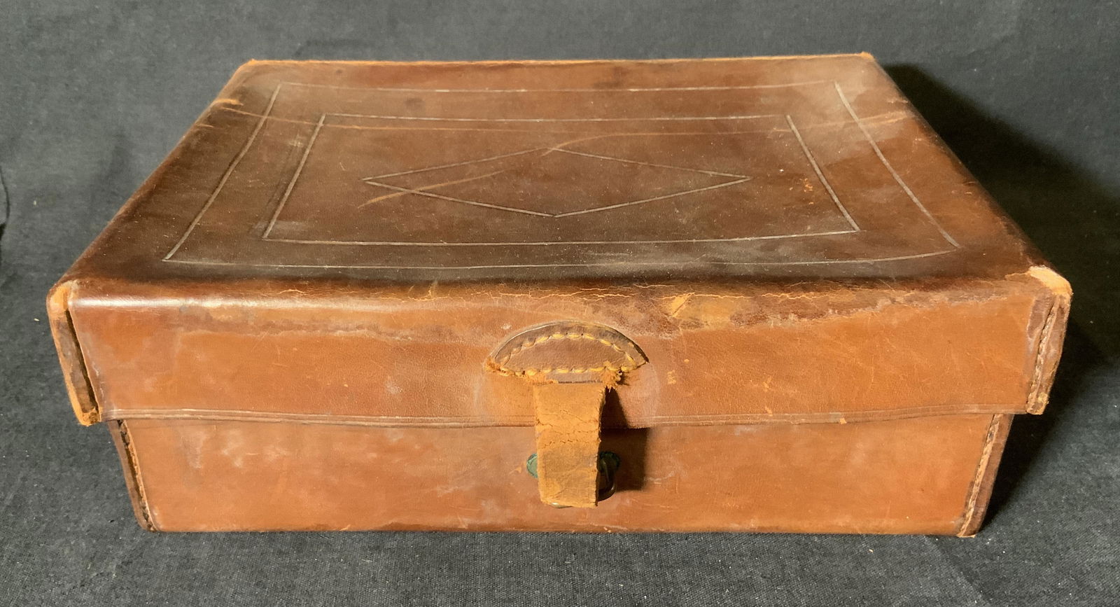 FA SADDLE SCHOOL Leather Box: FA SADDLE SCHOOL Leather Box, inscription reads ‘FA Saddle School Fort Sill, California’, measures 3 3/8 inches tall x 9 1/8 inches, surface wear and cracking to leather, Fa saddle school, leather