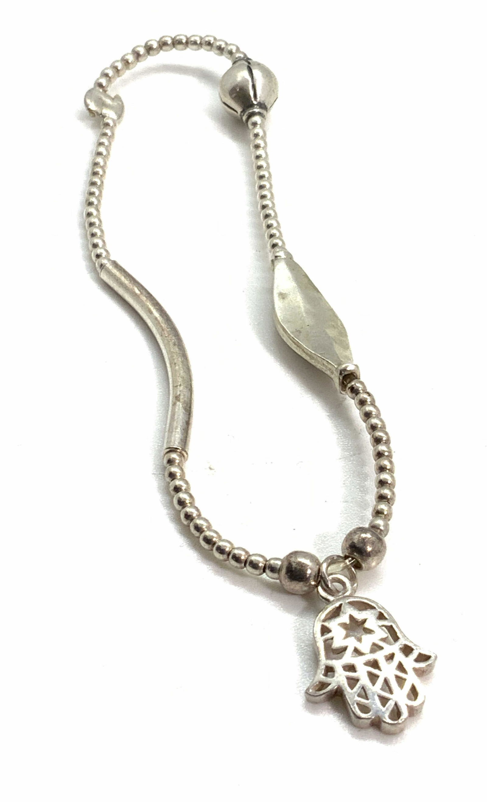Hamsa Sterling Silver Charm Bracelet, Jewelry: A sterling silver stretch charm bracelet. The bracelet features a charm in the style of the hand of Hamsa. Reverse of hand is signed 925. Approx. Diameter 2.5 in. Total weight: .23 ozt. Piece has some