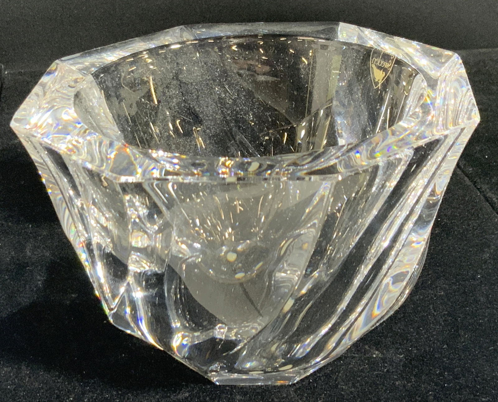 ORREFORS Signed Clear Crystal Tabletop Bowl: A thick walled crystal bowl crafted by Orrefors. The underside is signed Orrefors and the sticker to the side reads Orrefors, Sweden. Piece is weighty. Measures approx. 3.5H x 5W in. Underside has thr
