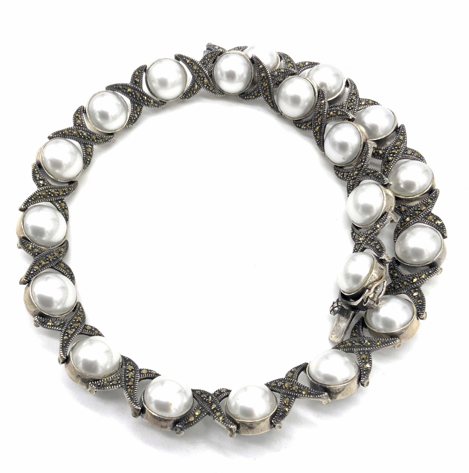 Vntg Sterling Silver Pearlescent Beaded Necklace: A vintage sterling silver necklace studded with marcasite and accented with pearlescent beads. The pearlescent beads are bezel set. The piece secures with a box clasp, clasp is marked 925. Necklace di