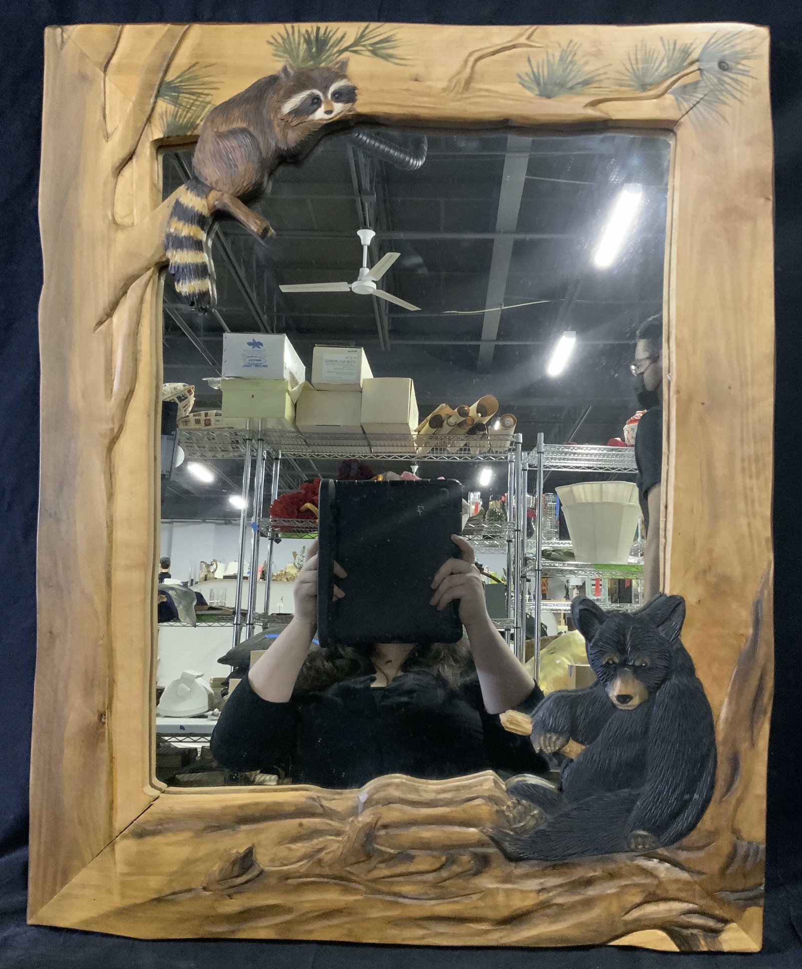 Hand Carved Wooden Cabin Mirror: Hand Carved Wooden Cabin Mirror, frame to mirror made of carved wood with the outline of a tree carved into it as well as a black bear and a raccoon, frame appears to be made of lighter toned wood, me