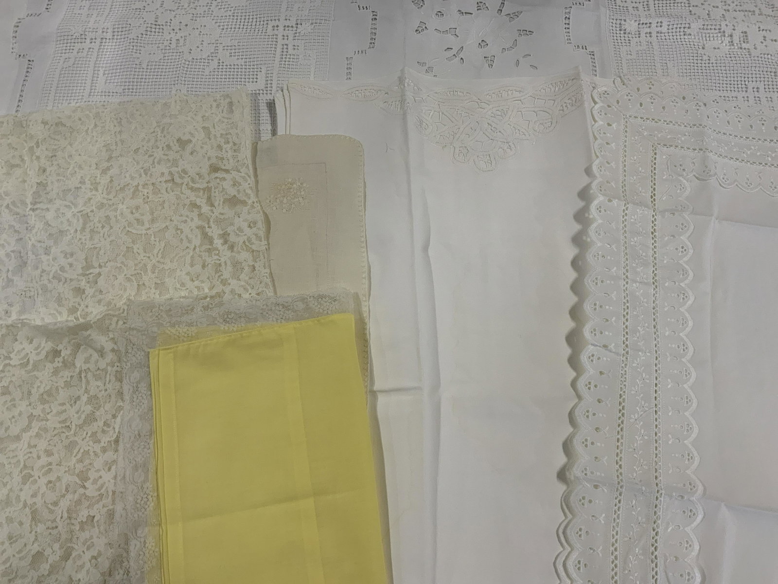 Lot 12 Pillowcases & Tablecloth: Lot 12 Pillowcases & Tablecloth, label to one pillow case reads ‘Wamsutts 50% polyester 50% combed cotton’ no apparent inscriptions or labels to other pieces, smallest pillow case measures 11 1/8