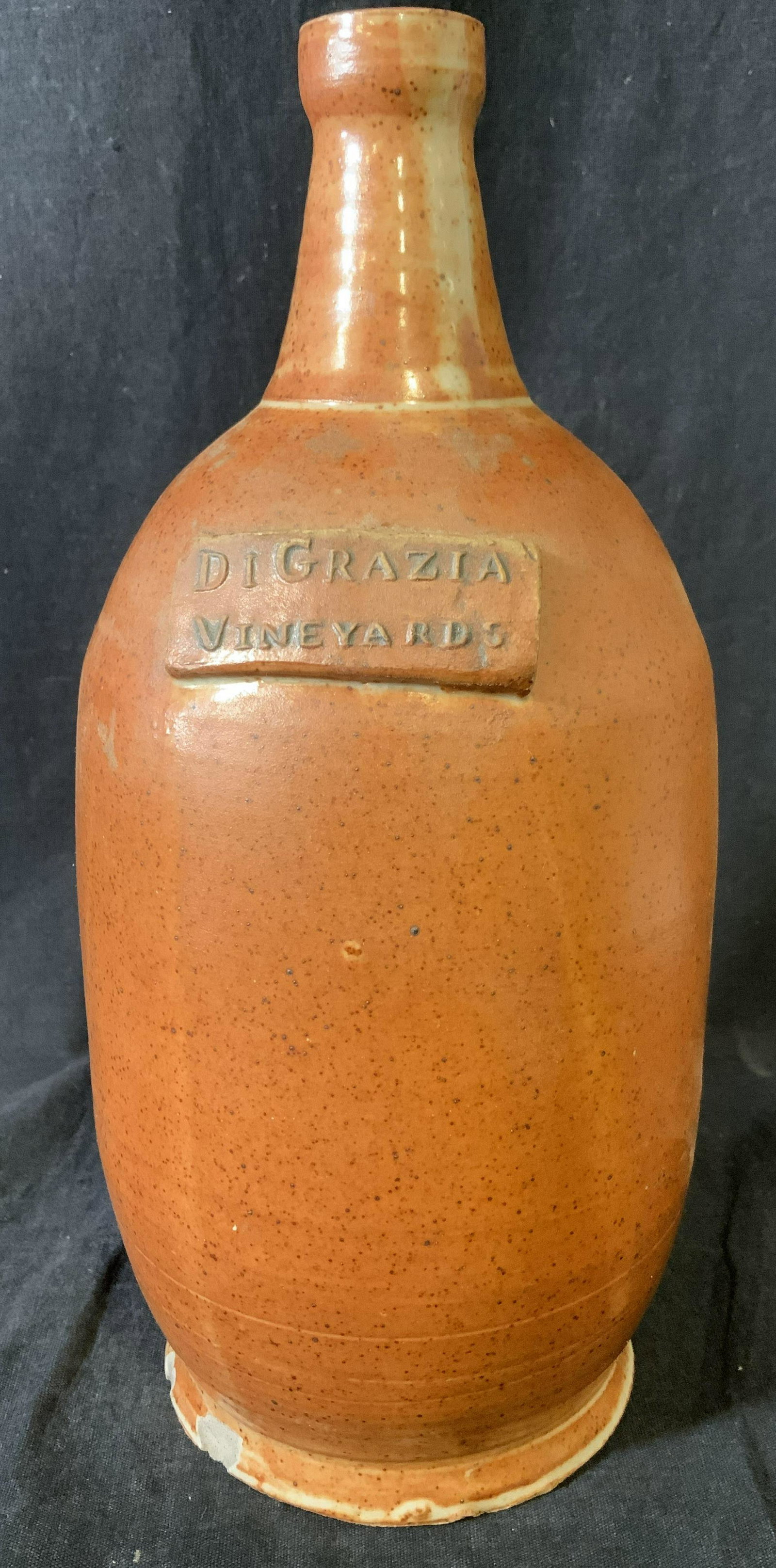 DIGRAZIA VINEYARDS Earthenware Jug: DIGRAZIA VINEYARDS Earthenware Jug. Rust toned glaze. Wear is consistent with age and use. Property of a Fairfield County Connecticut Winery. Measures approx 11 inches H and 5.5 W. Earthenware jug, de