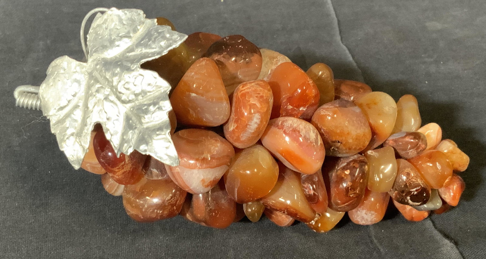 Pair Polished Natural Stone Grapes: Pair Natural Stone grapes, grapes appear to be made of carnelian/red agate and the other made of clear Quartz, both have metal accents wiring the stones together as well as making the leaf of the vine