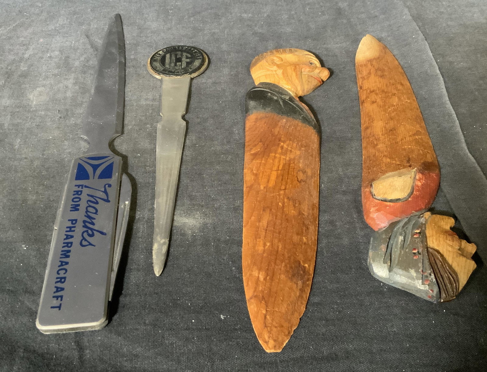 Group Lot 4 Metal & Wooden Letter Openers: Group lot 4 Metal and wooden letter openers, label to one reads ‘Thanks From Pharmacraft’, text other reads ‘Inter County Farmers Woodridge’, two of the group are made of metal, two of the gro