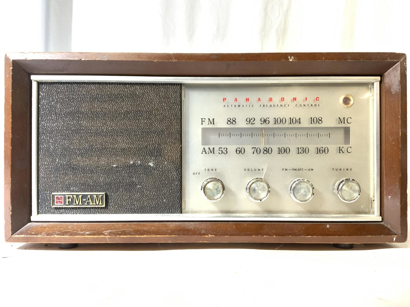 Vintage PANASONIC National Model Re 784: Front of Radio reads PANASONIC. AM FM Vacuum Tube radio. Piece has 4 knobs on right side including Tone, Volume, FM AM, & Tuning. Radio appears to have wooden shell. Piece measures approx 17 inches lo