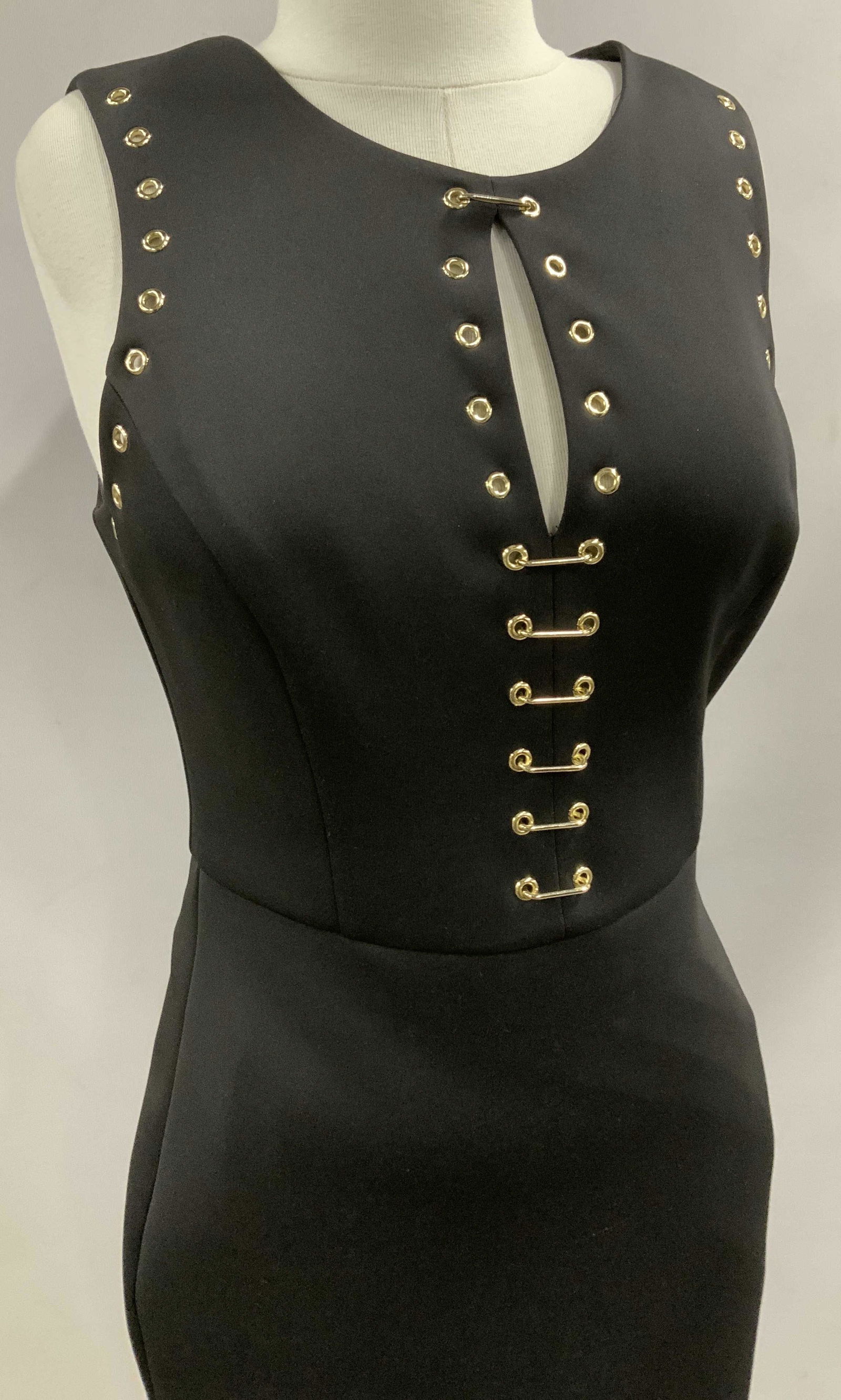 Vintage GUESS Sleeveless Cocktail Dress: Sleek Vintage Guess Los Angeles Dress with gold tone Grommet Holes bordering Sleeves and center hem with safety pin style. Size 8, backside zipper, Label Affixed. Possibly polyester. High crew neck. A