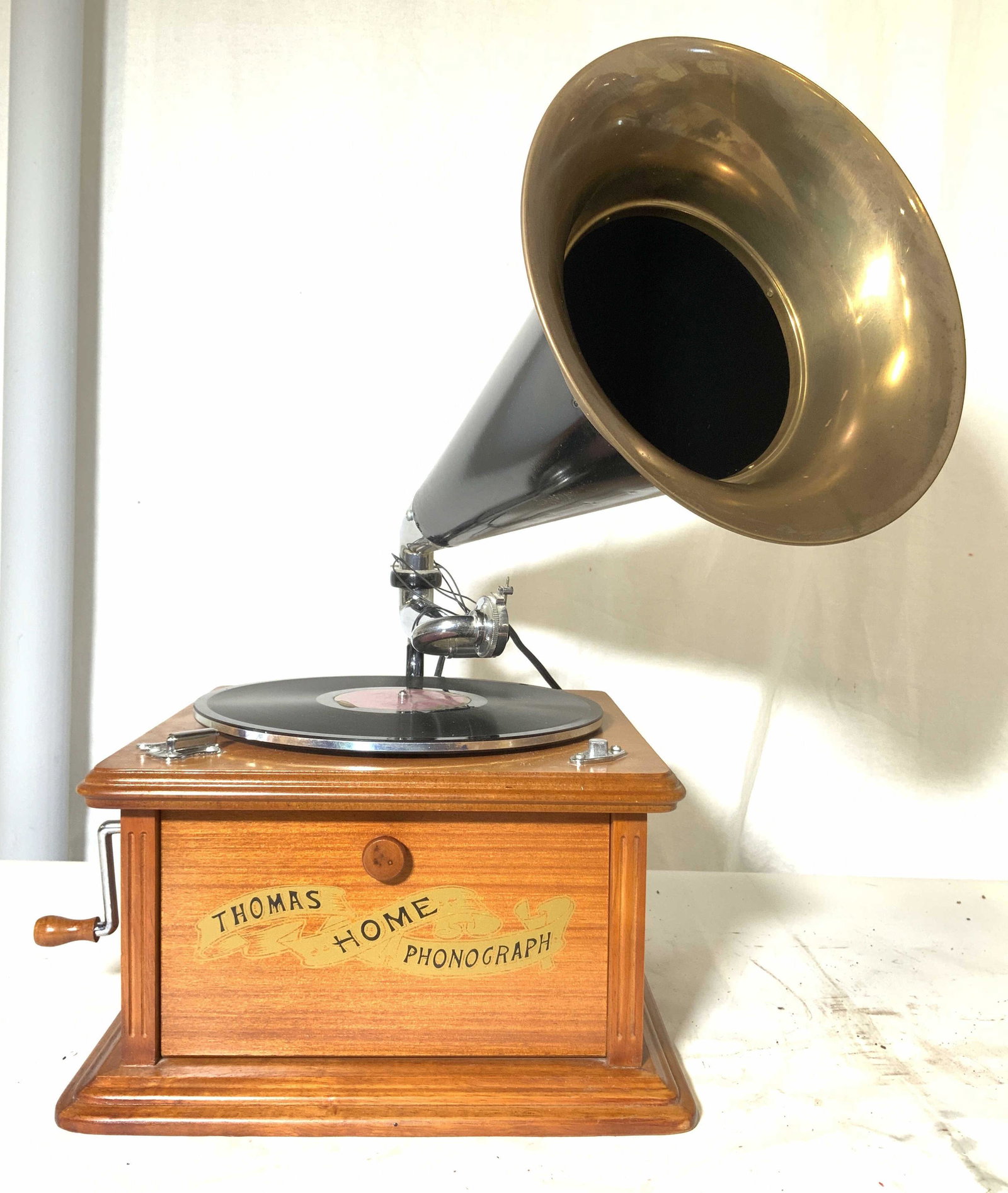 THOMAS COLLECTORS EDITION Phonograph RADIO: Underside has tag which reads THOMAS COLLECTORS EDITION RADIO NO. 000742 . Front of piece flips down to reveal radio area with 4 black toned knobs, Tuning, Volume, Tone, AM-FM AFC. Left side of piece 