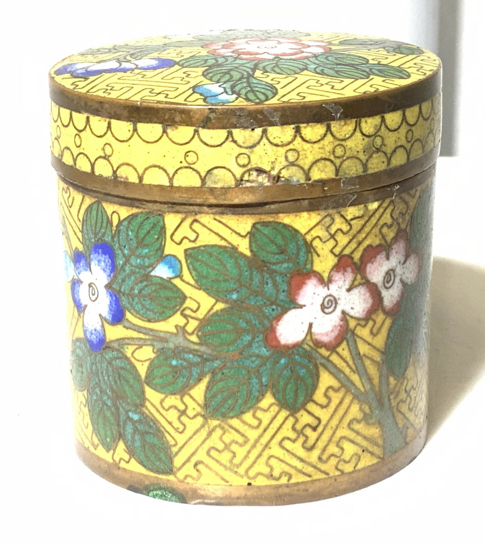 Collectible Chinese Cloisonné Lidded Canister: Yellow exterior enamel with floral decor, verso and interior Light Blue -JingTai enamel after Ming Dynasty . This is a vintage lidded piece painted on brass. Some fissures to inner enamel consistent w